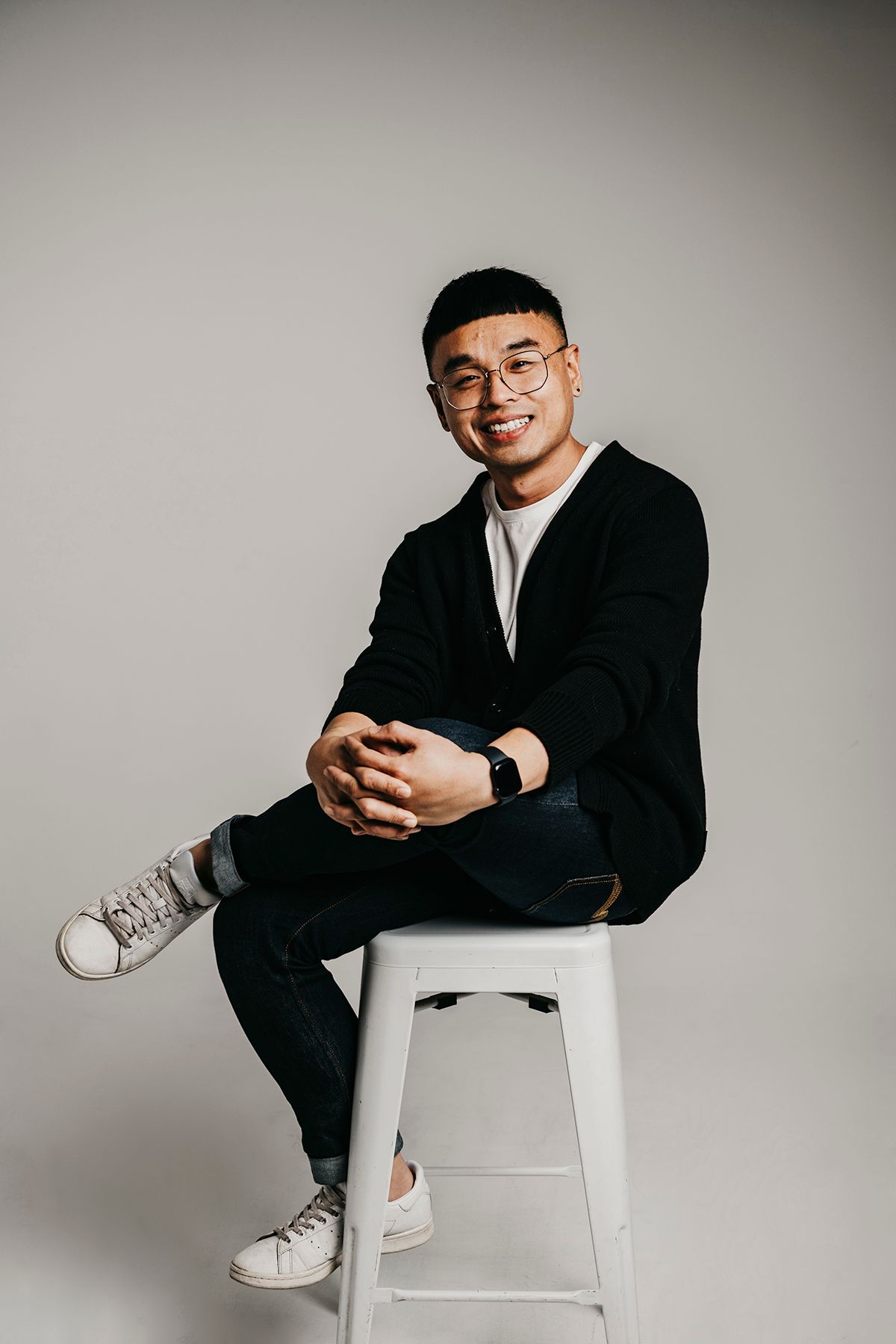Man sitting on stool with leg crossed during a studio portrait session - Zara King Photography, Sydney Australia