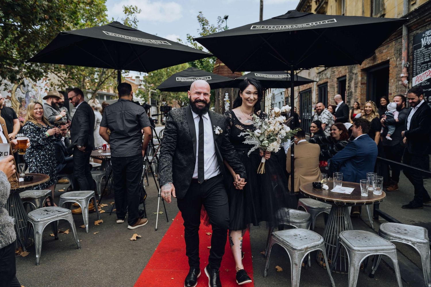 Alternative bride and groom walking down the aisle after their ceremony in Fitzroy, Melbourne - Zara King Photography, Australia