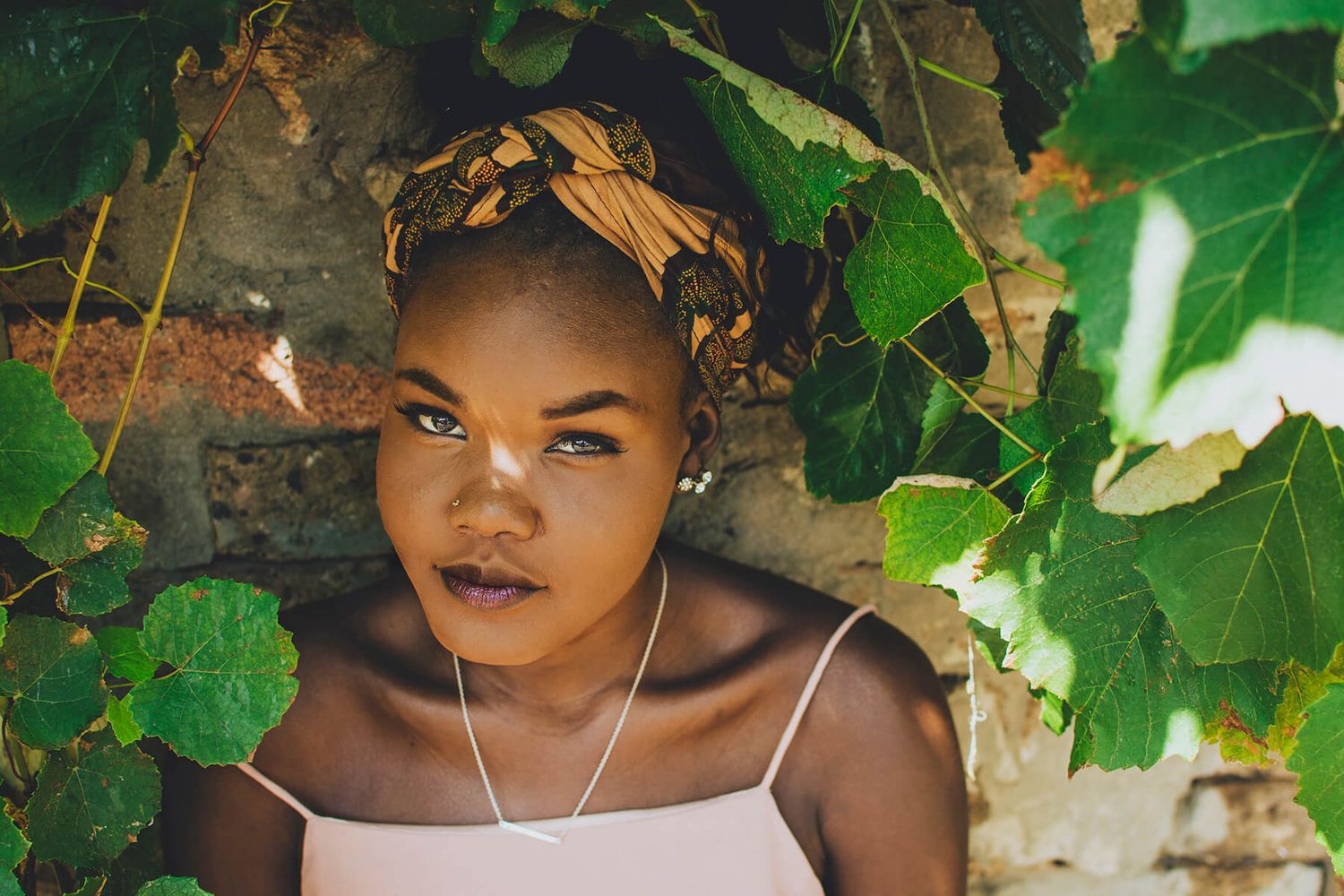 Girl surrounded by greenery and mottled light during headshot session outdoors in Newtown - Zara King Photography, Sydney Australia
