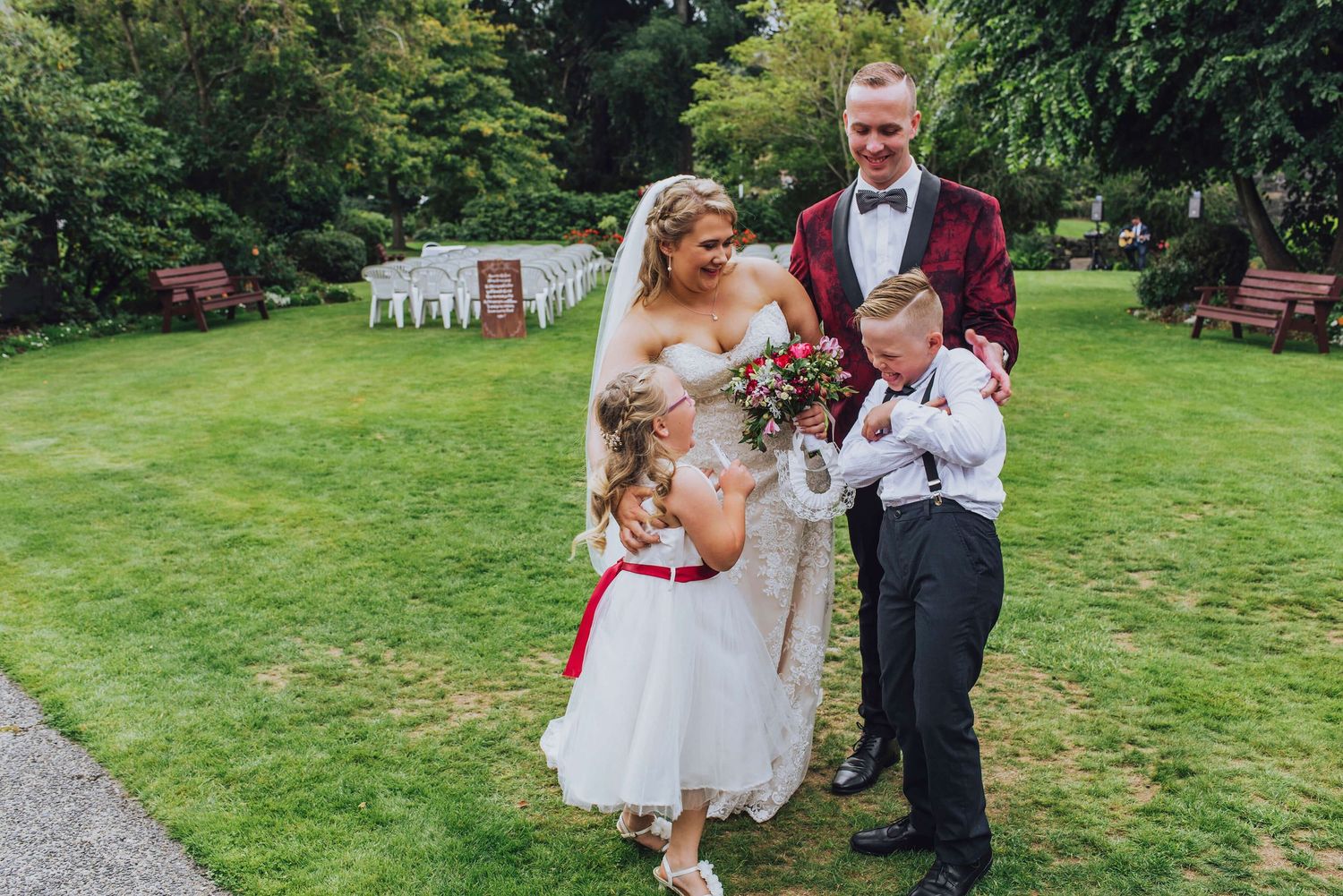 Bride and groom tickling son and daughter after ceremony in Dunedin, NZ - Zara King Photography