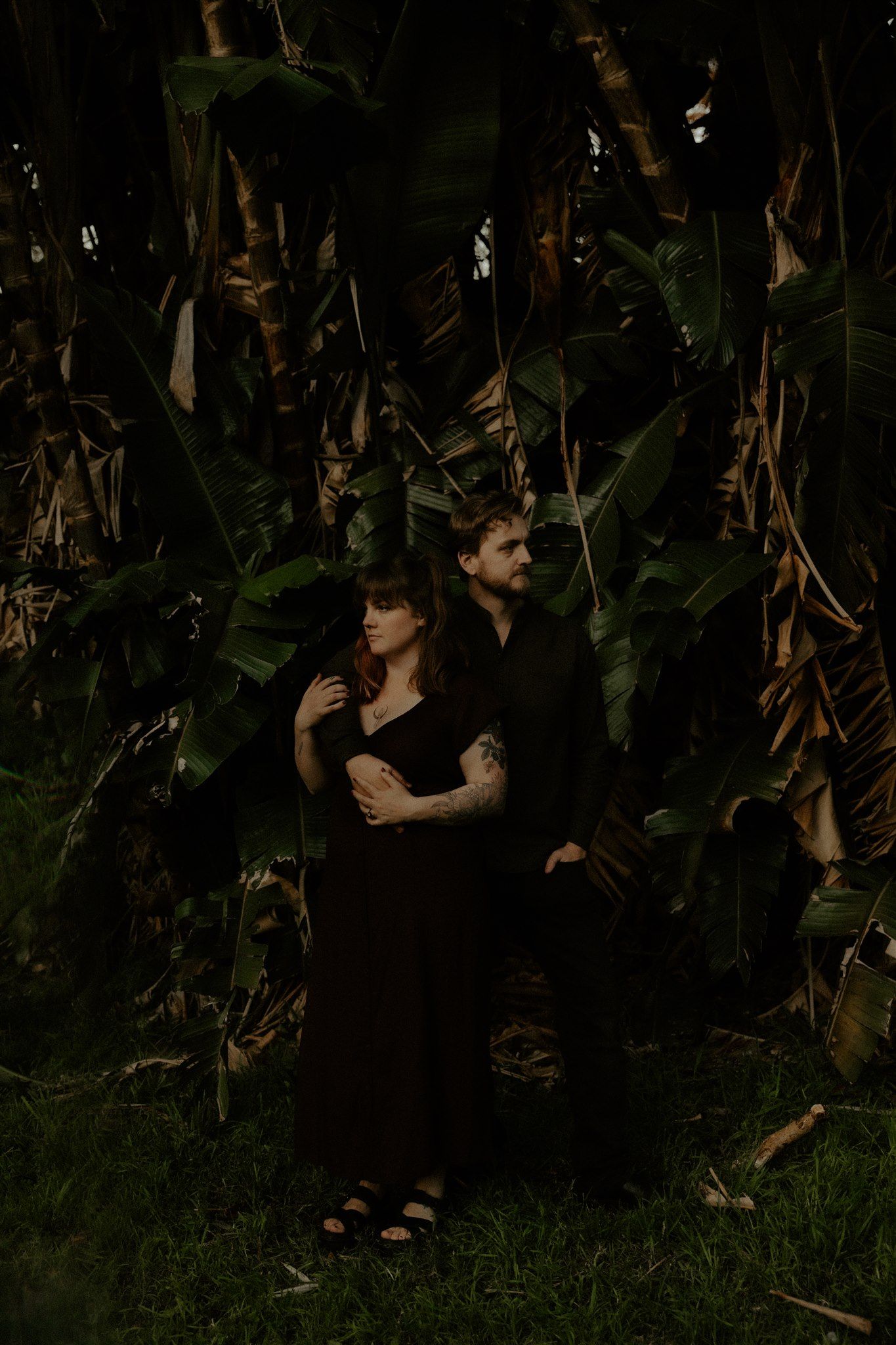 Zara King and fiancé standing in front of banana trees