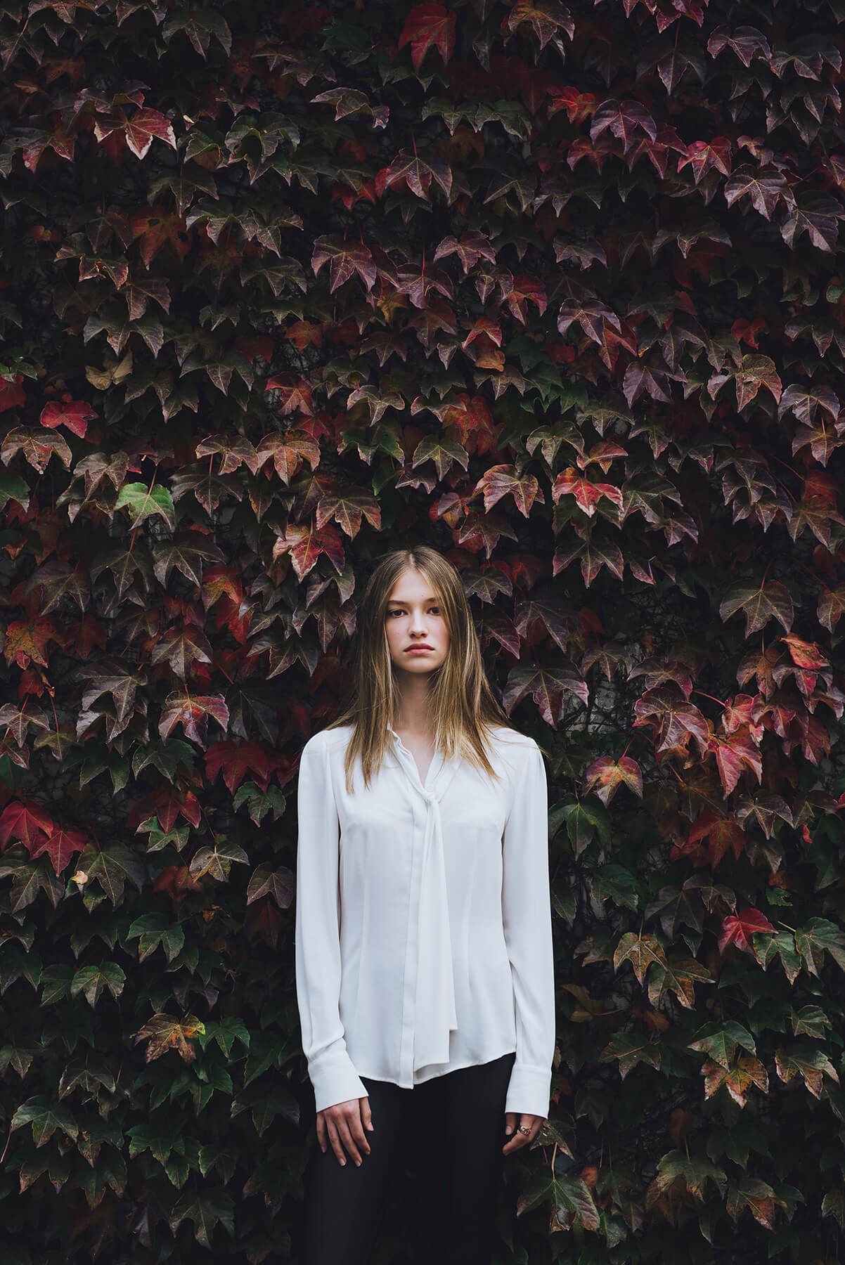 Girl standing against red ivy during modelling photo shoot in Newtown - Zara King Photography, Sydney Australia