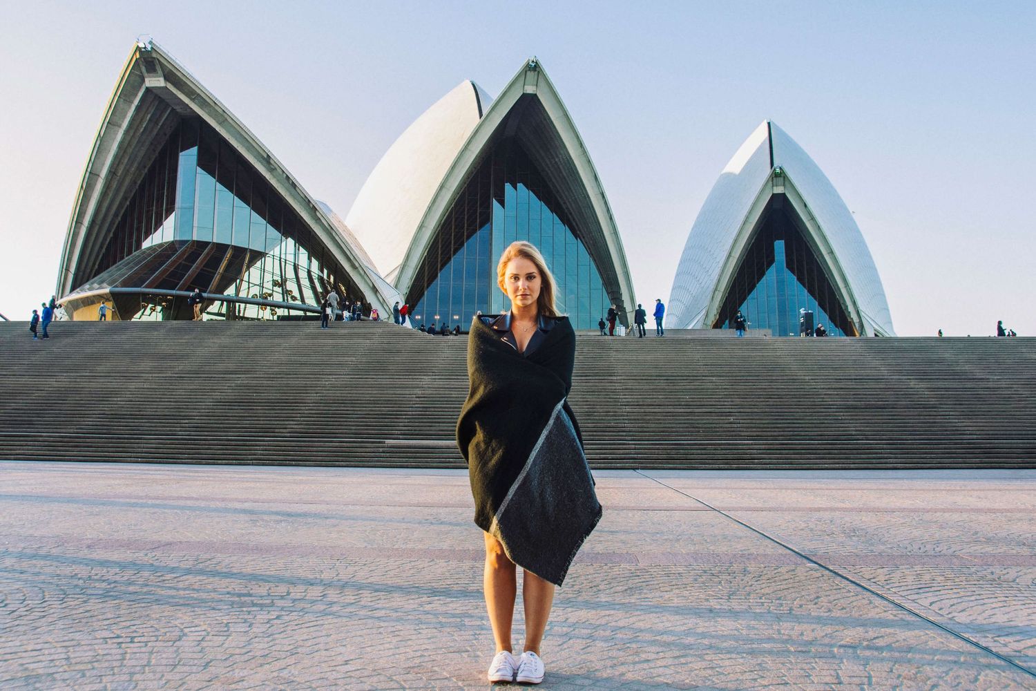Girl wrapped in blanket standing in front of Opera House at sunset - Zara King Photography, Sydney Australia