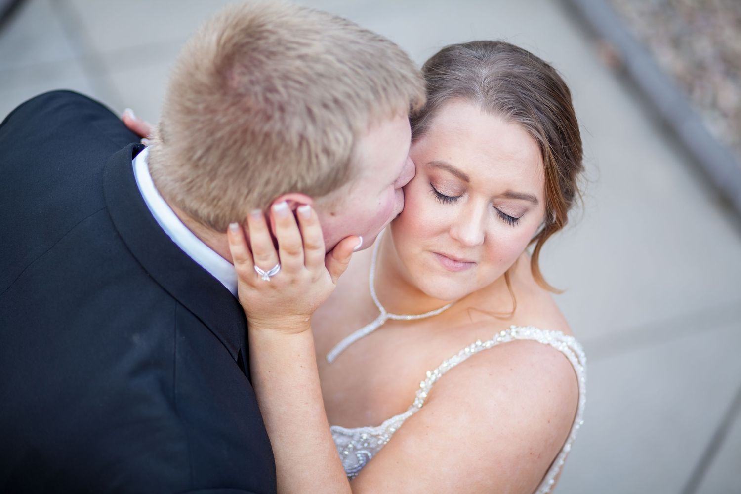 Intimate moment between newlyweds captured in soft natural light.