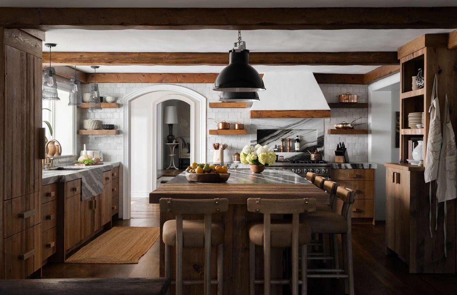 Rustic residential kitchen with exposed wood beams and pendant lighting creating a warm, natural interior.