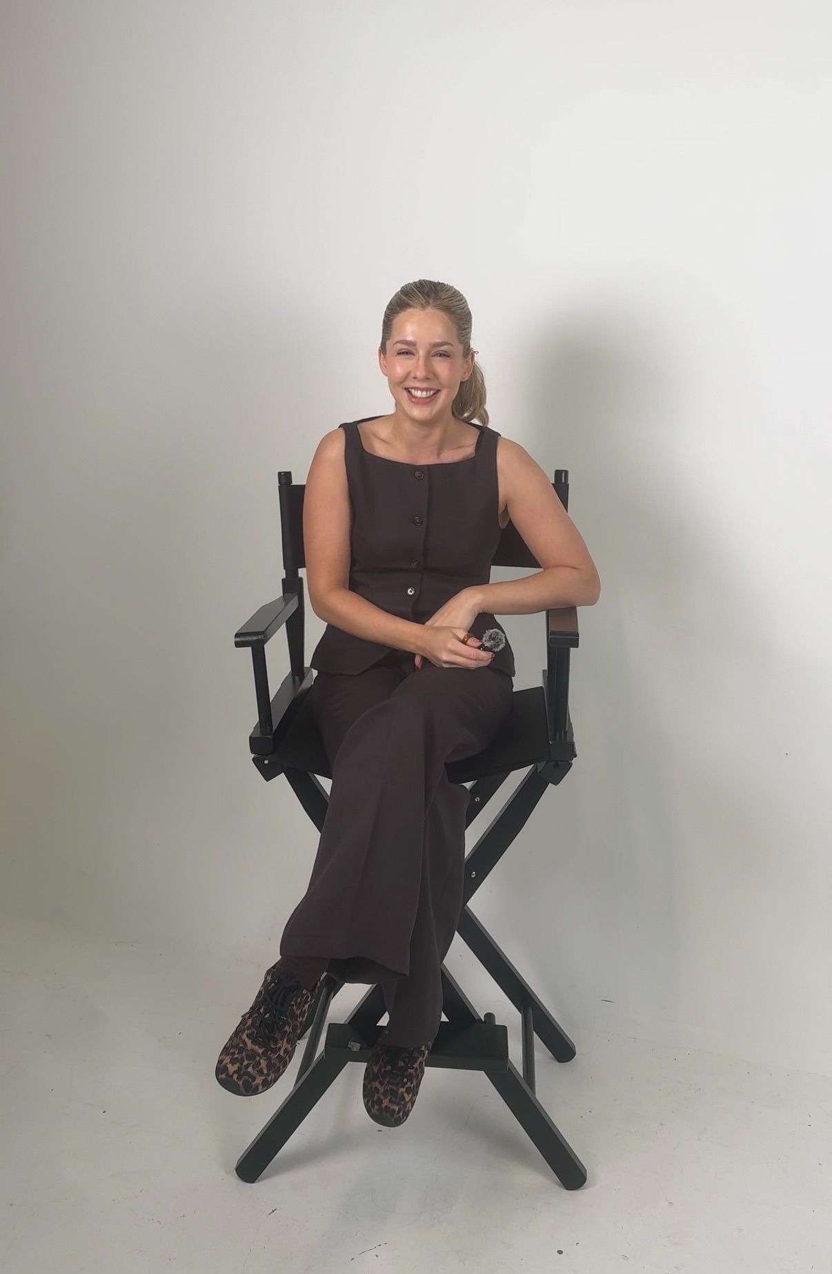 Candid moments captured in director's chair against white studio background.
