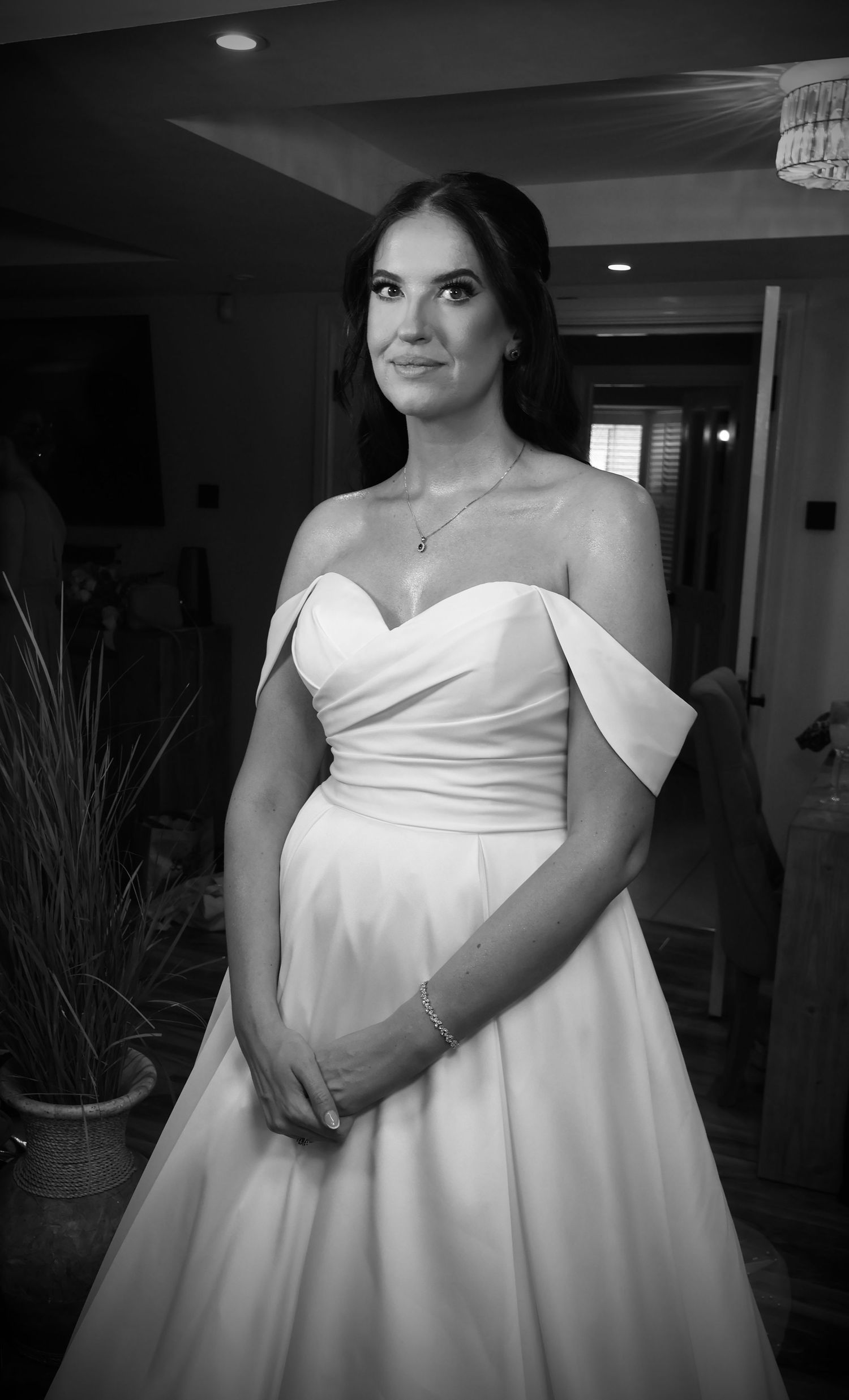 Black and white portraits of a bride in an elegant strapless wedding gown.