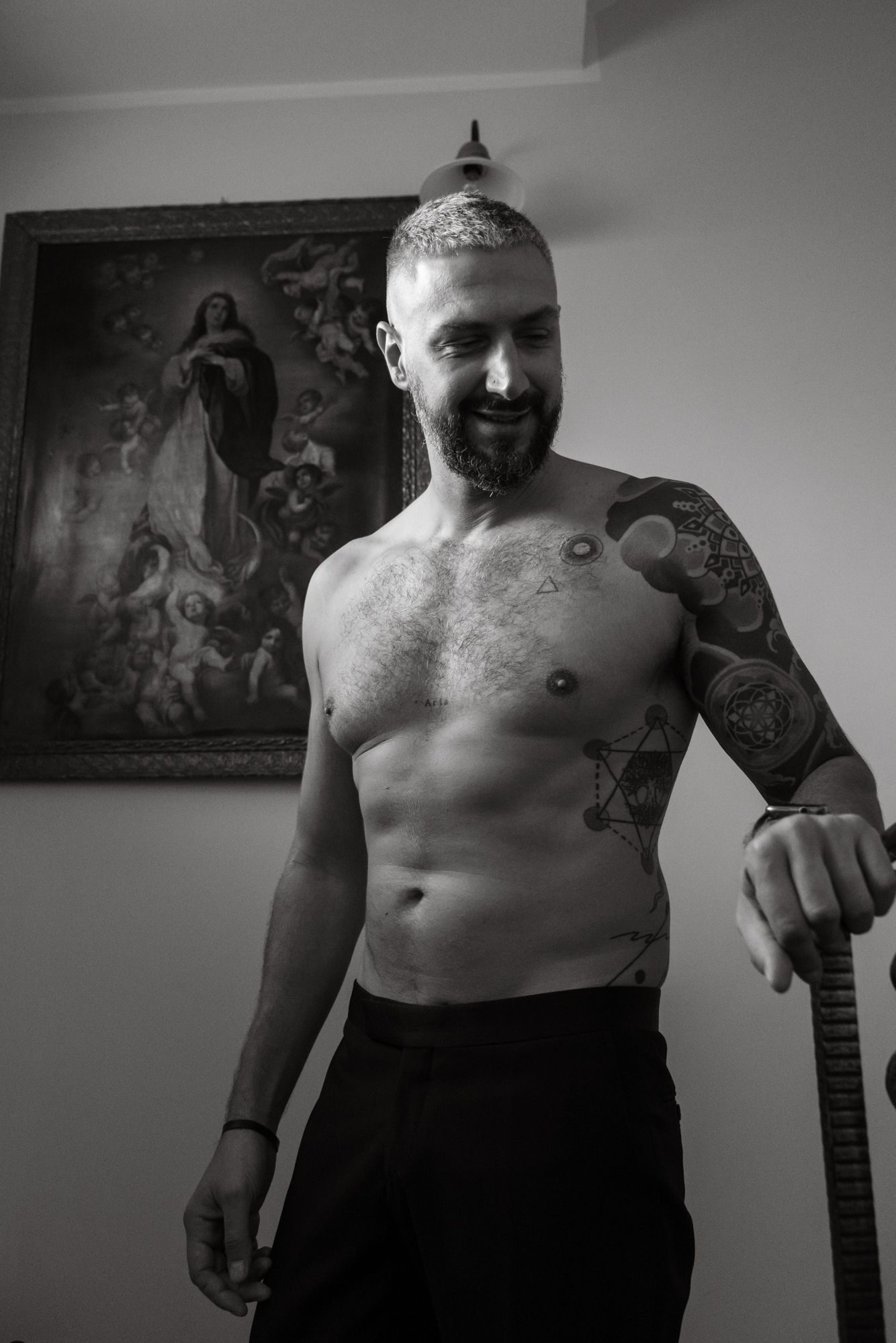 Black and white portrait series showing tattoos and bare torso against an indoor backdrop.