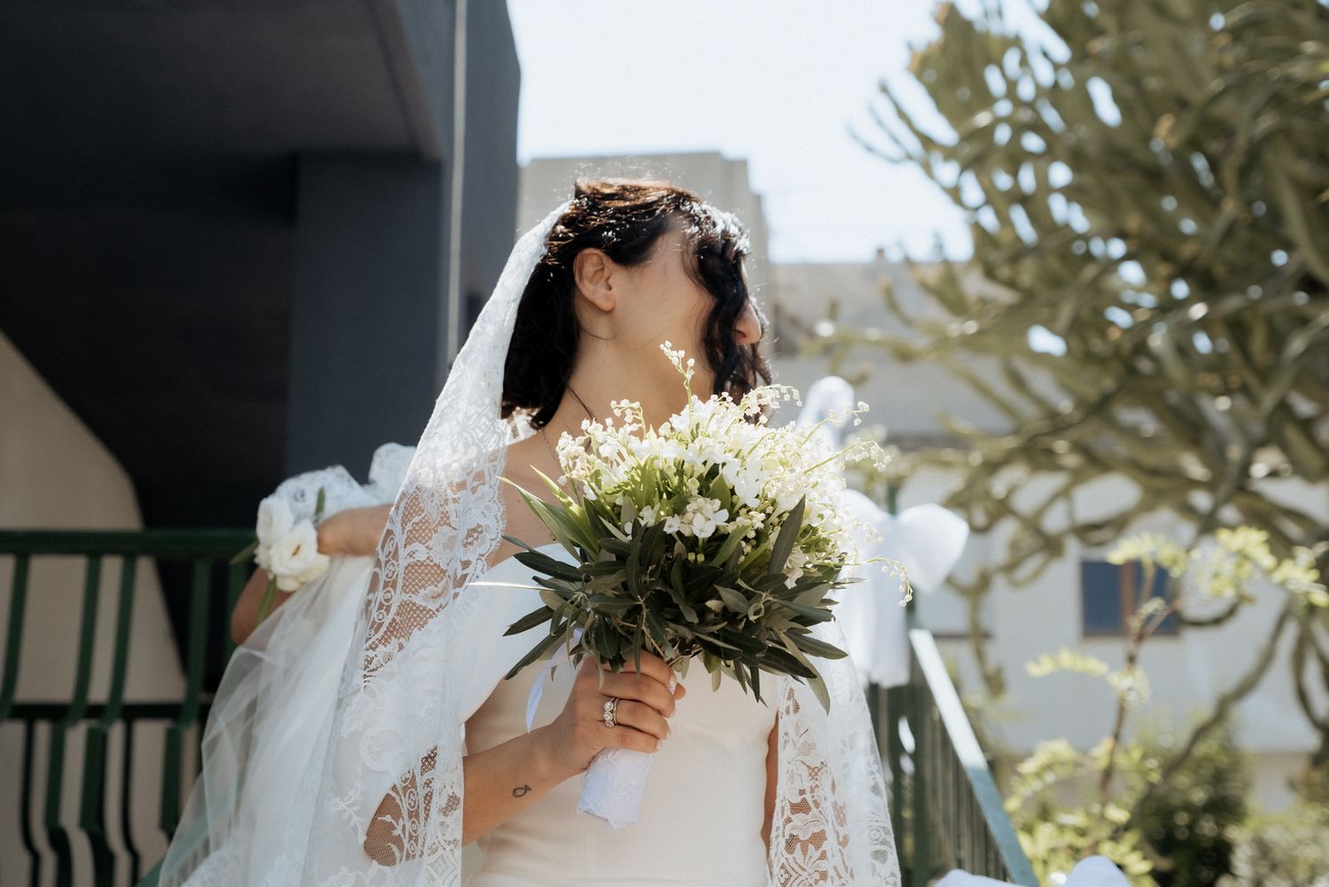 An elegant bridal portrait session outdoors with greenery and natural lighting.