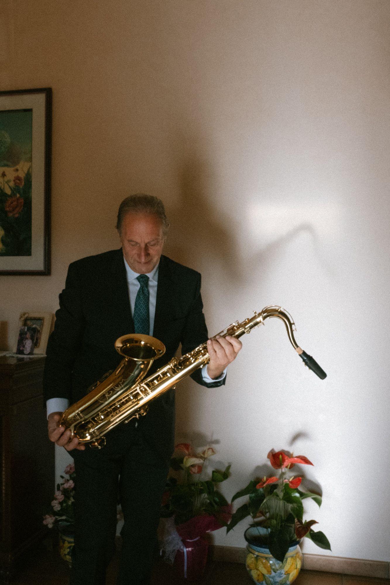 A sequence of photos showing a person playing a saxophone next to potted flowers in a dimly lit room.