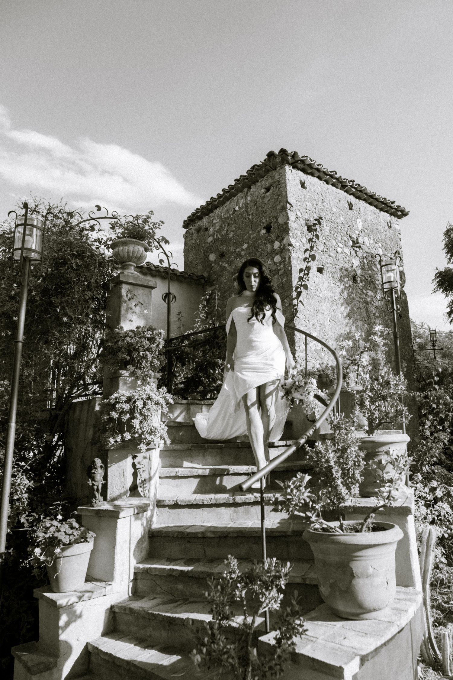 Black and white photos capture moments on a Mediterranean garden terrace with potted plants.