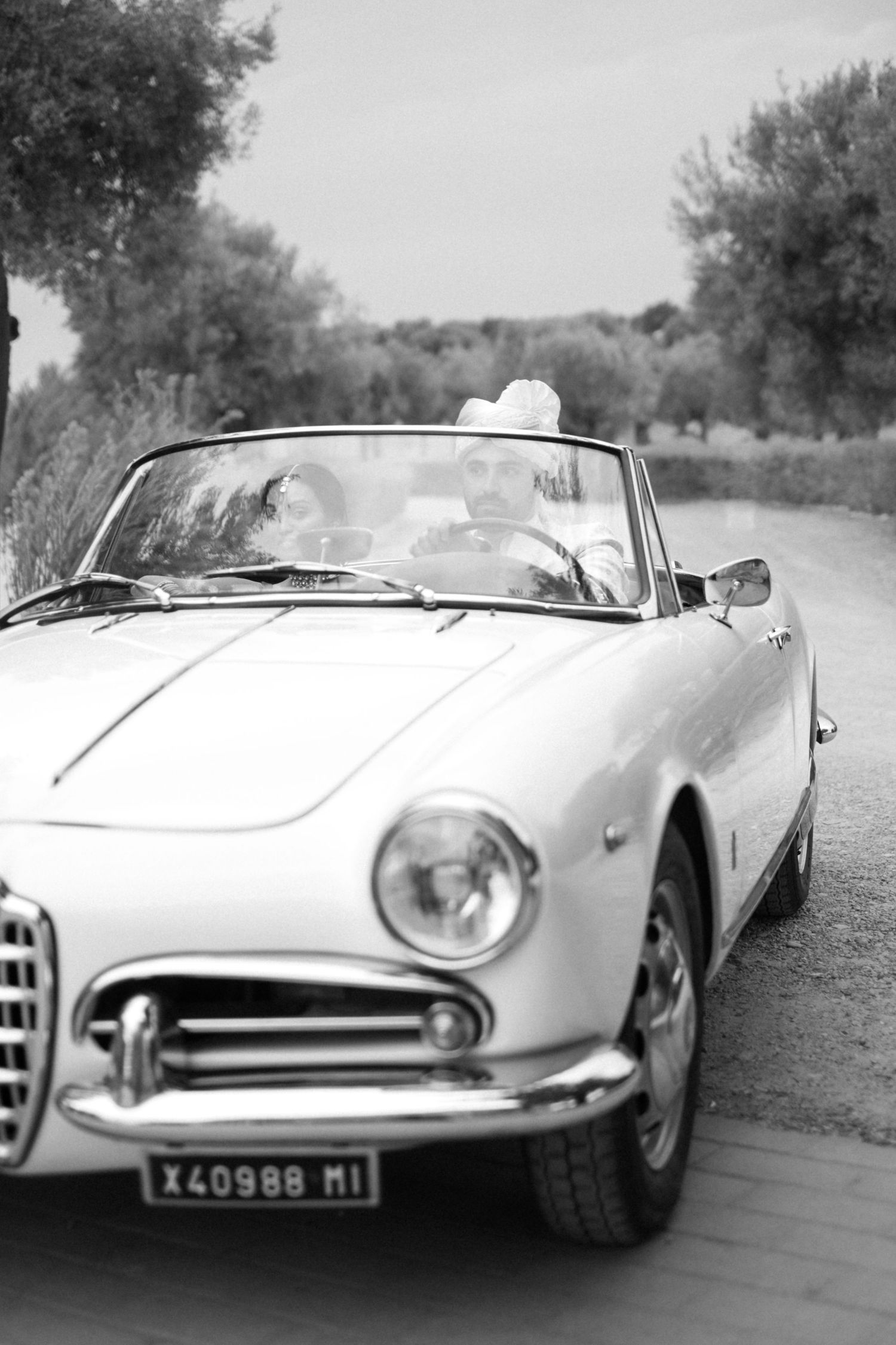 Classic white vintage Ferrari convertible photographed from multiple angles on a rural road.