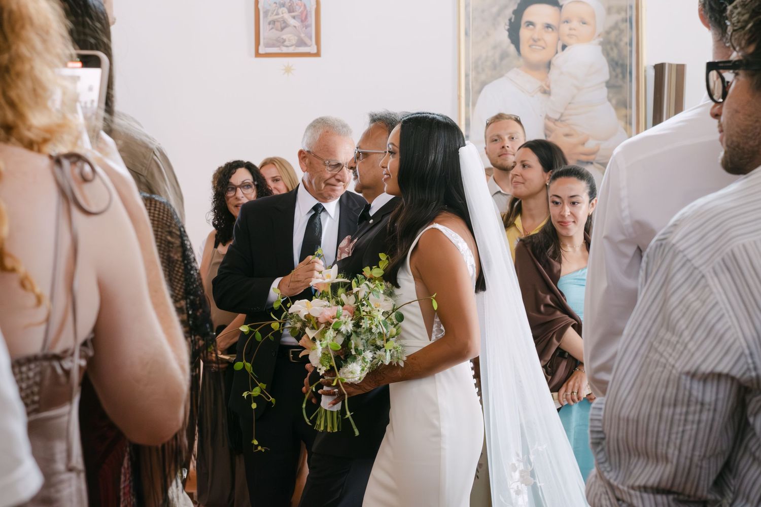 Wedding guests mingle and socialize during an elegant indoor reception celebration.