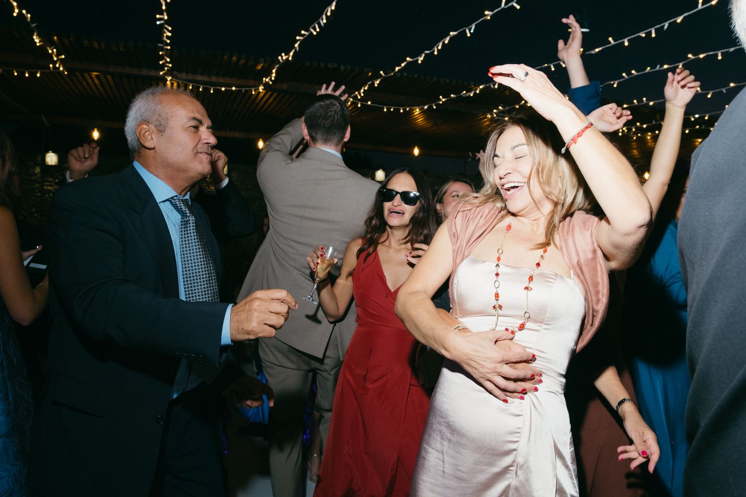 People dancing and enjoying themselves at a crowded party or celebration event.