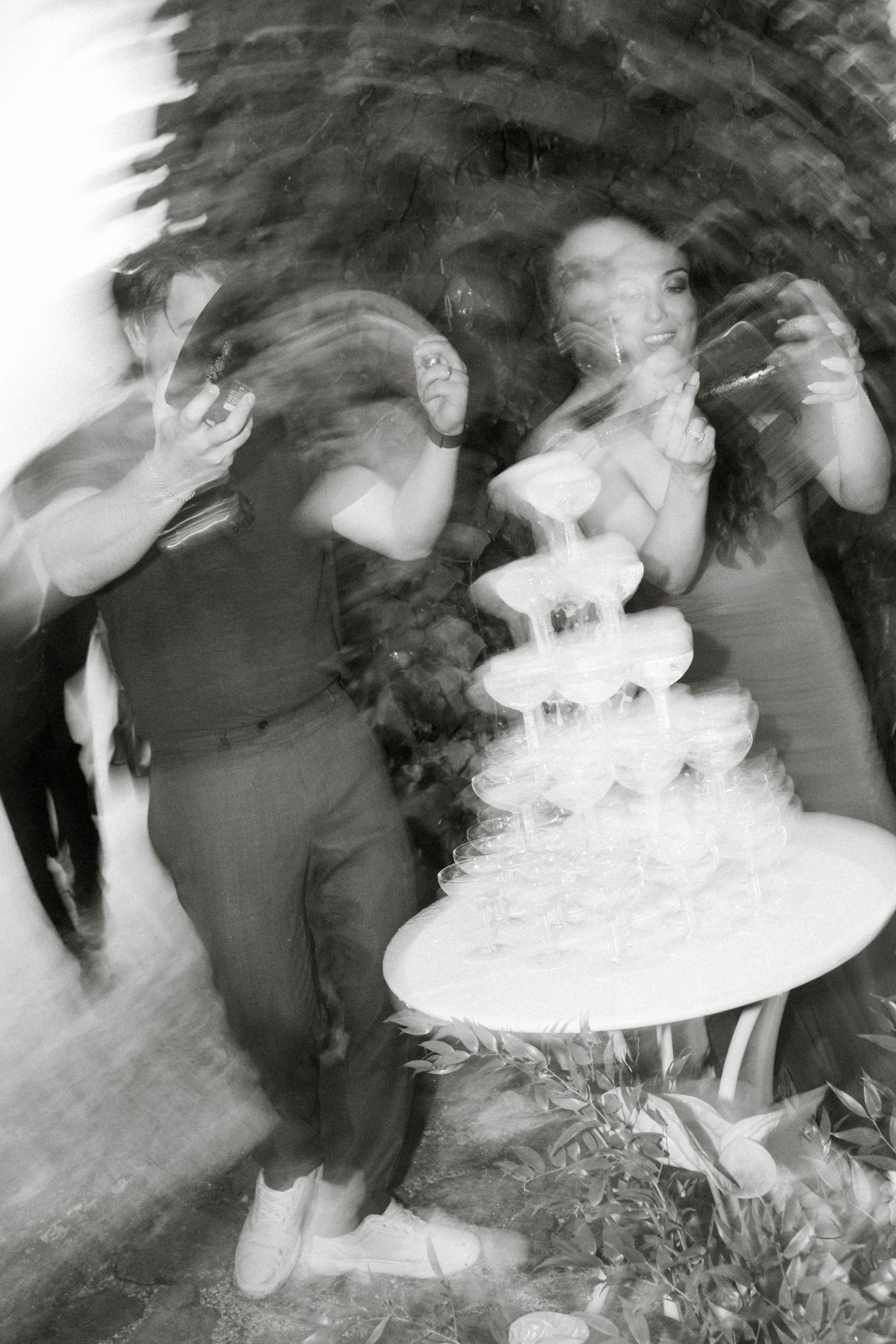 Artistic black and white motion blur photo of wedding celebration dancers.