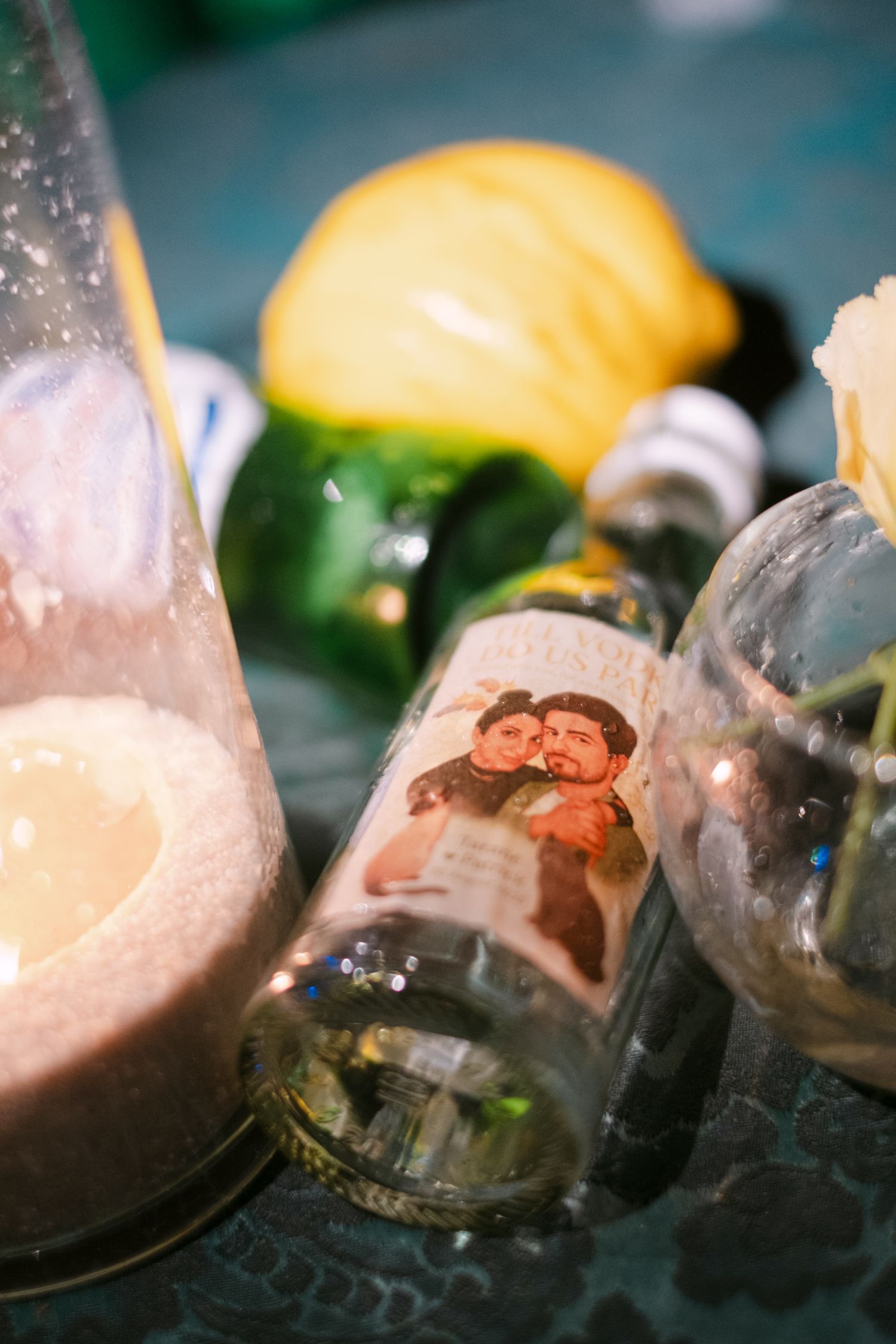 Ice cubes and citrus fruits create an artistic bar setup with moody lighting.