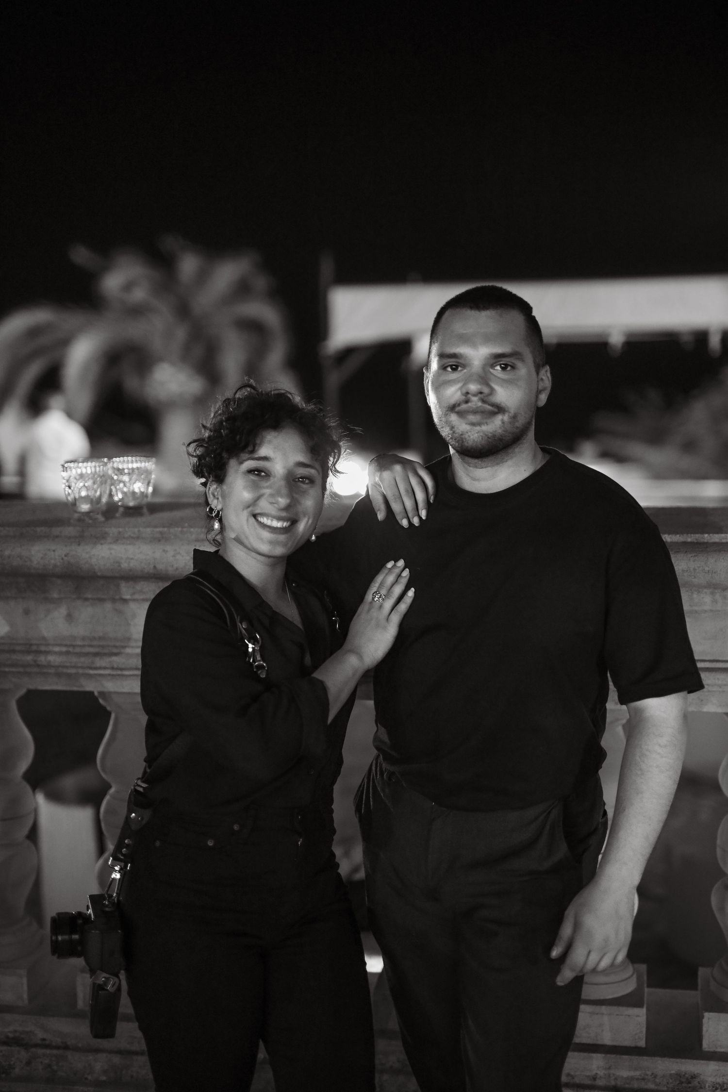 A series of black and white photos showing couples posing together outdoors at night.