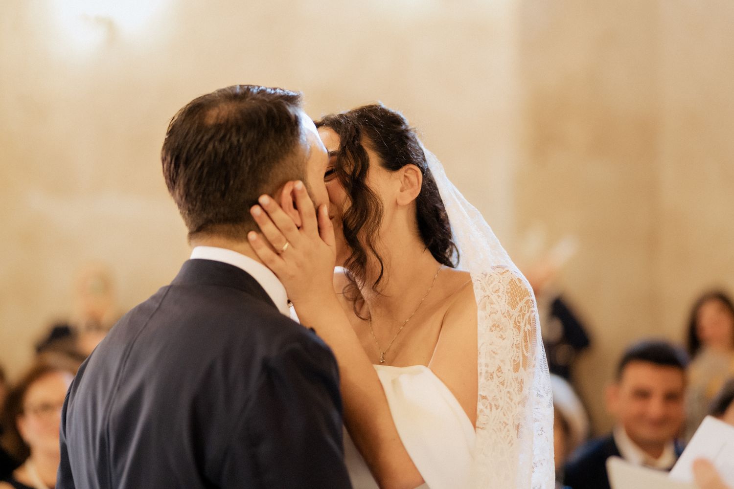 Intimate moment captured during a wedding reception with soft lighting.
