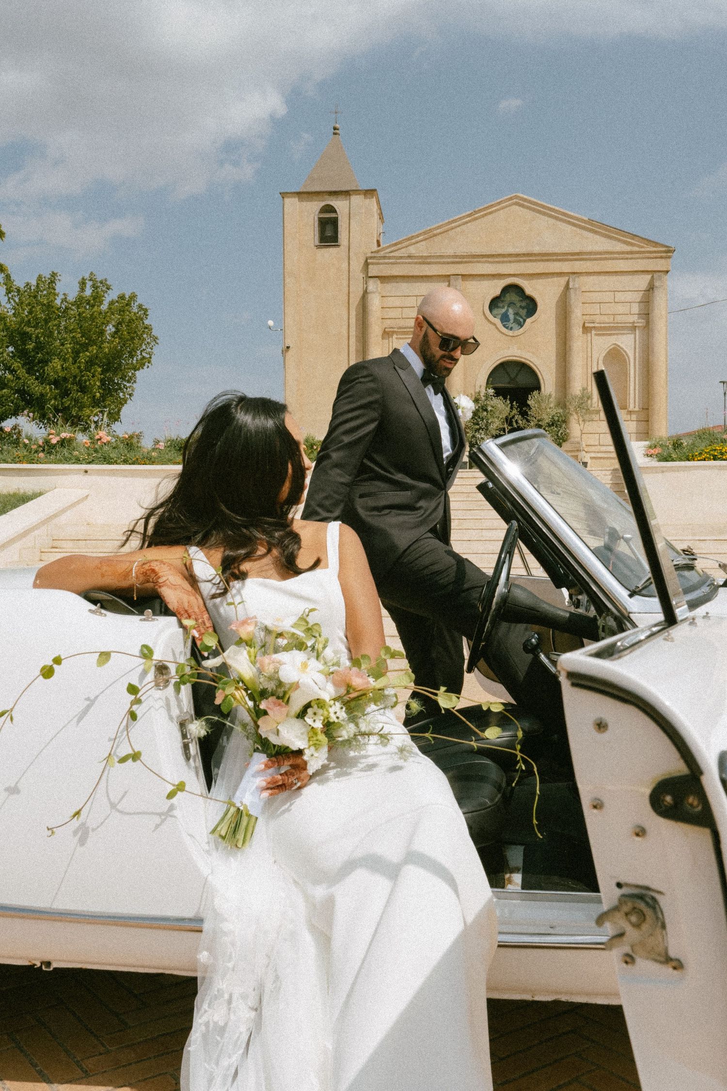 A series of romantic wedding photos showing a couple dipping and posing in front of a classic church building.