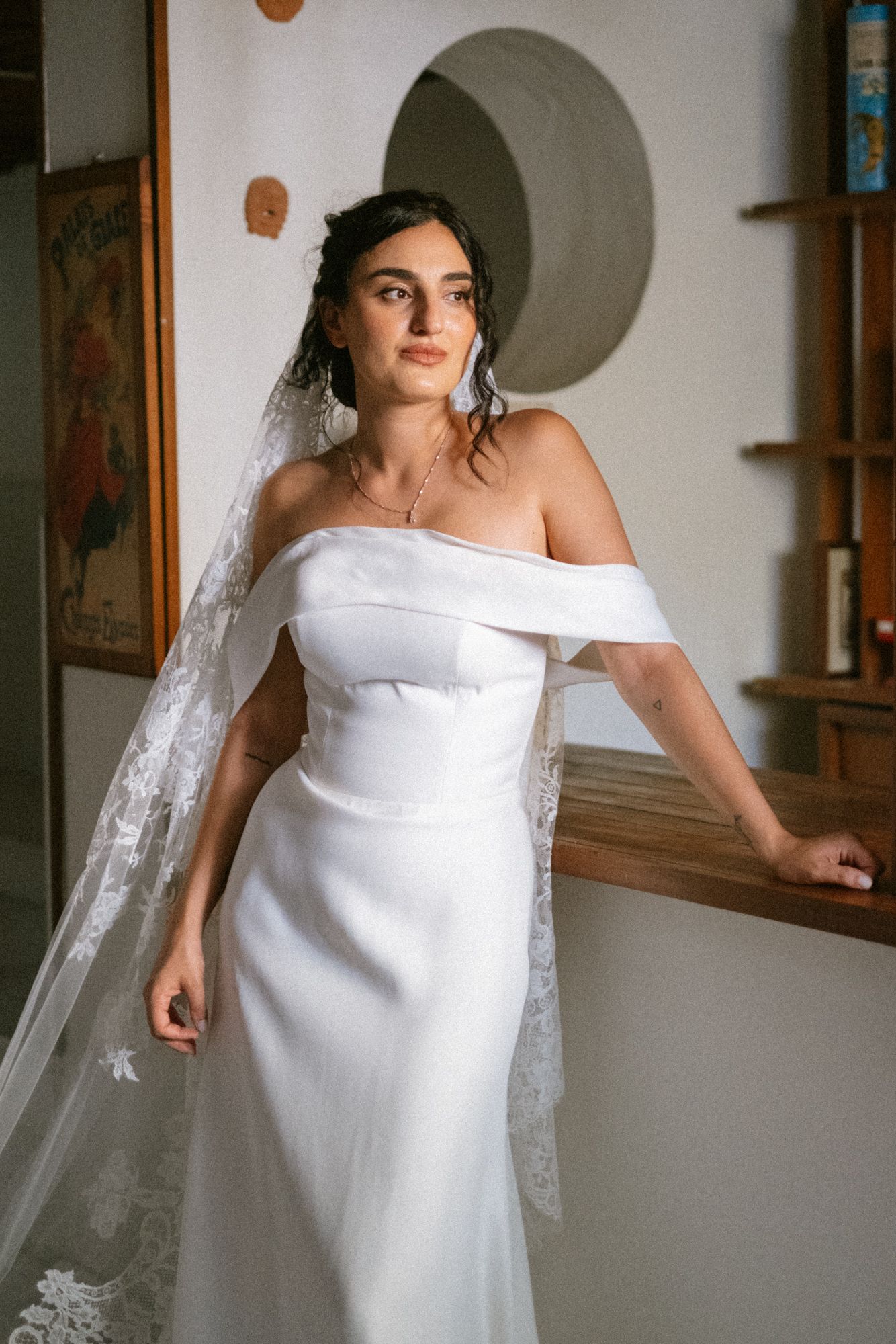 Elegant off-shoulder white wedding dress shown from different angles in an indoor setting.