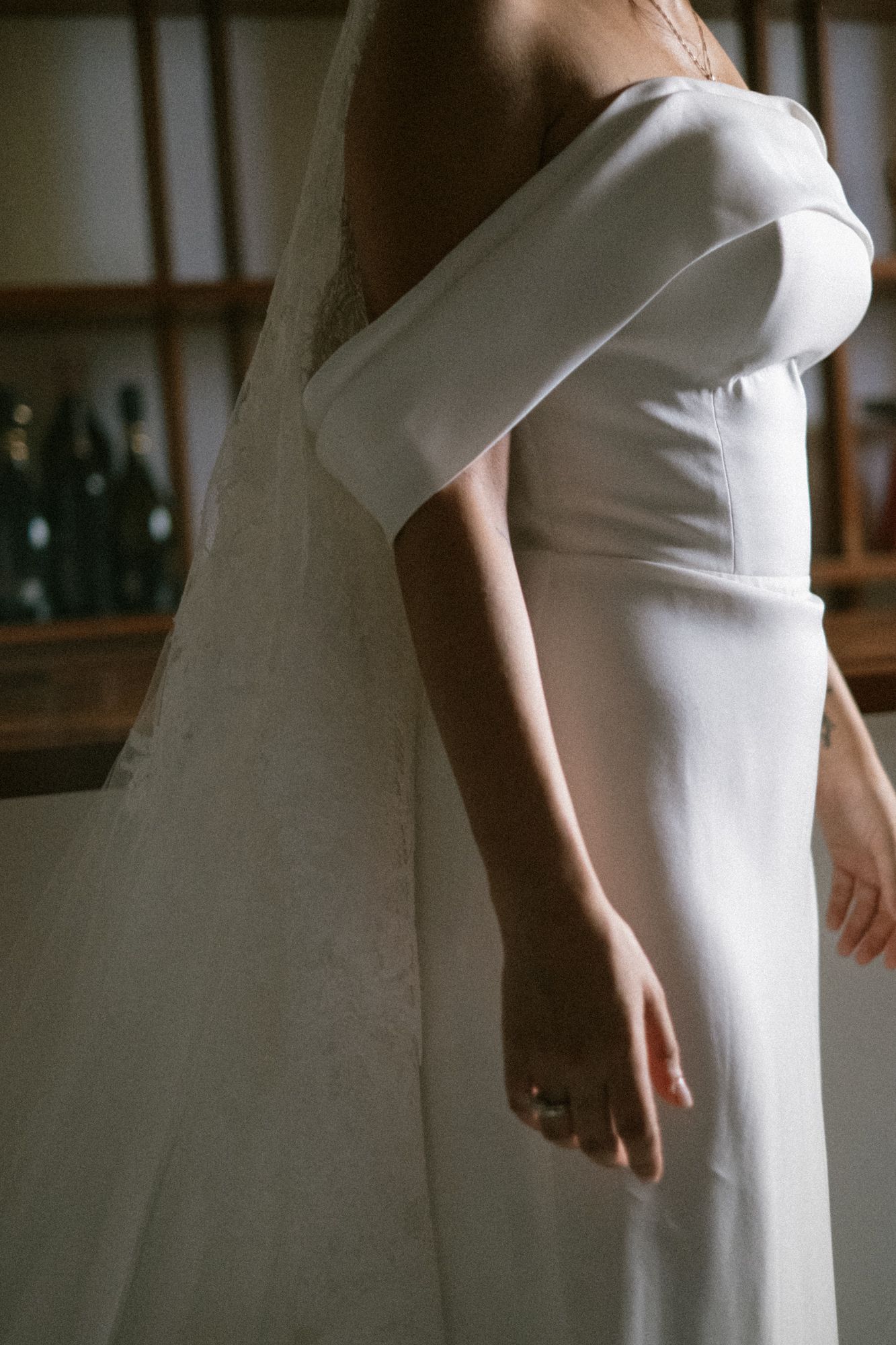 Elegant white wedding dress with structured puff sleeves shown in detail against a minimalist background.