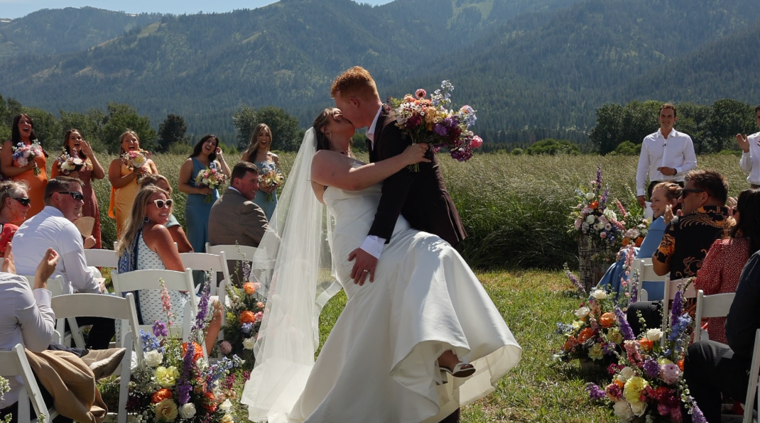 Scenic mountain vista during an outdoor wedding celebration with guests.
