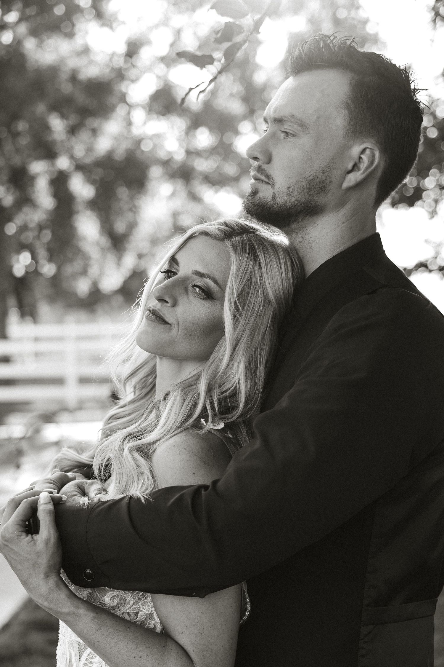 A romantic black and white photo series showing tender embraces and intimate moments between a couple outdoors.