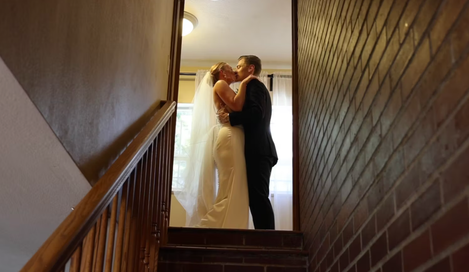 A sequence of silhouetted figures in a dark hallway creating a dramatic wedding moment.
