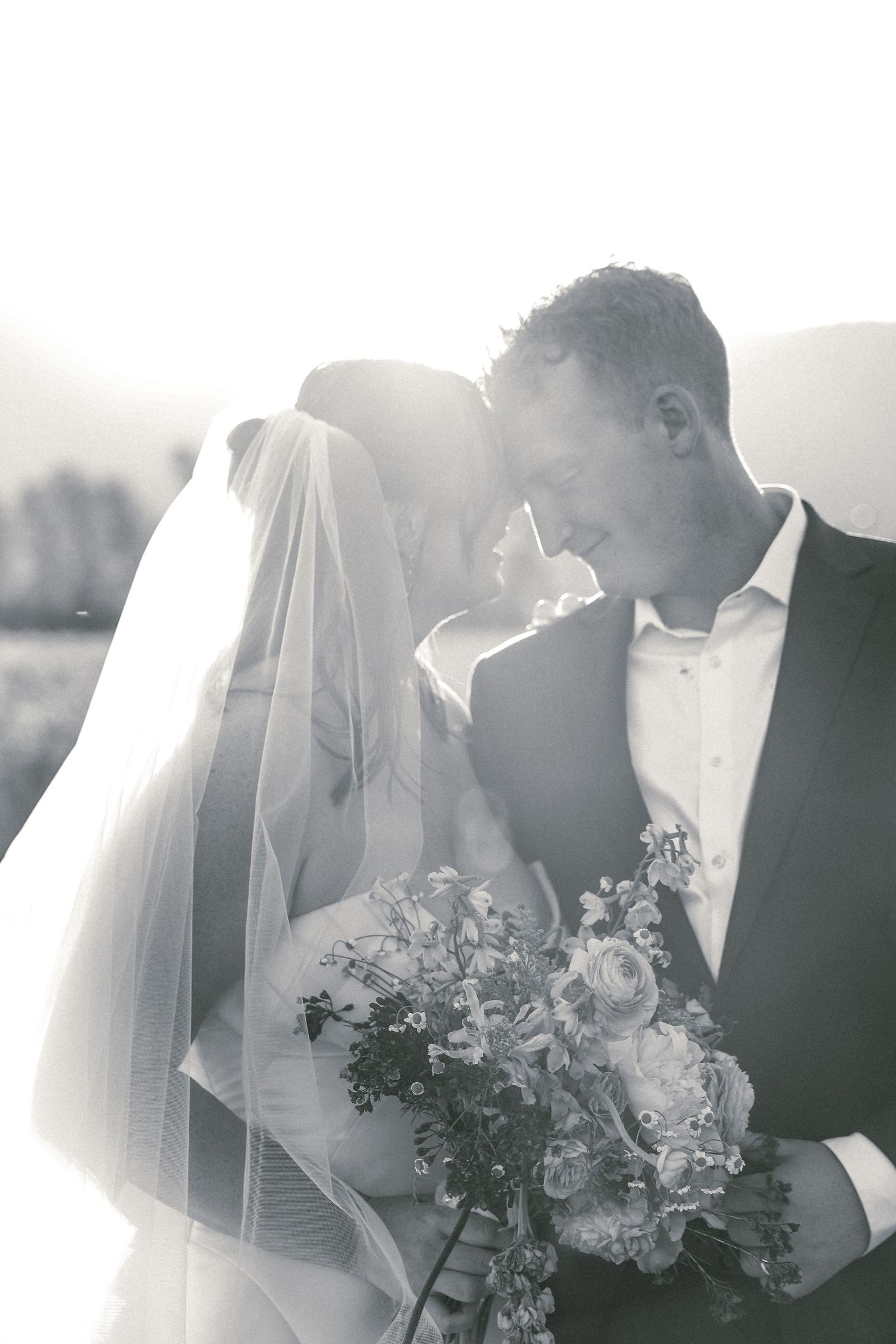 Black and white wedding photography sequence showing romantic moments between newlyweds.
