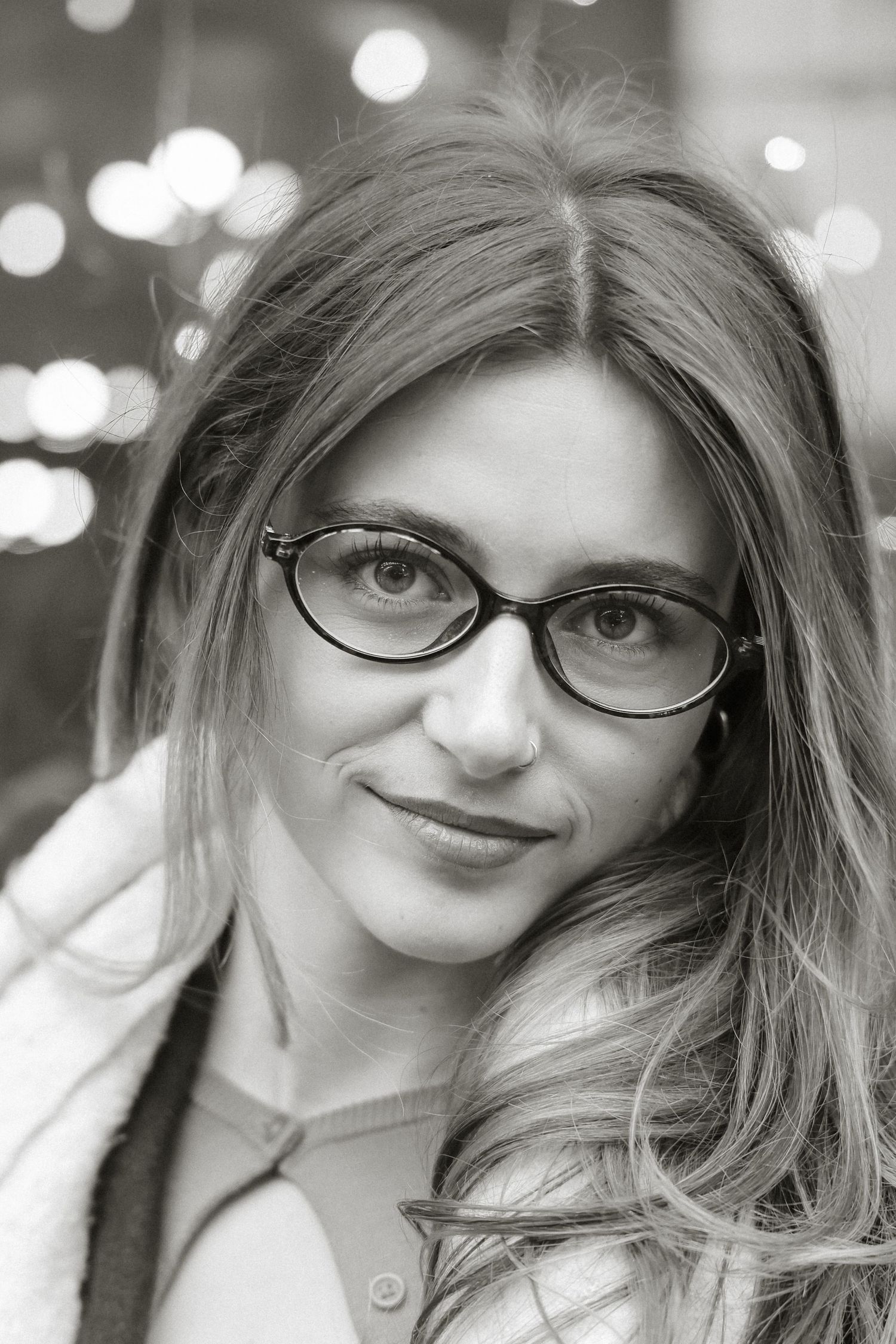 A sequence of black and white portraits with soft bokeh lighting effects.