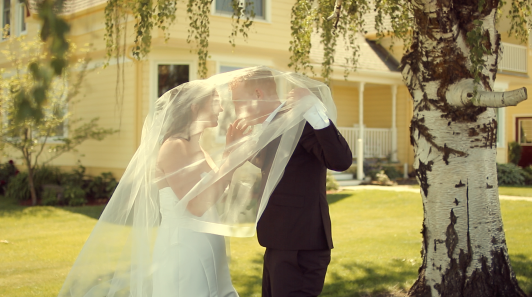 Elegant wedding ceremony setting with hanging floral decorations and natural light.