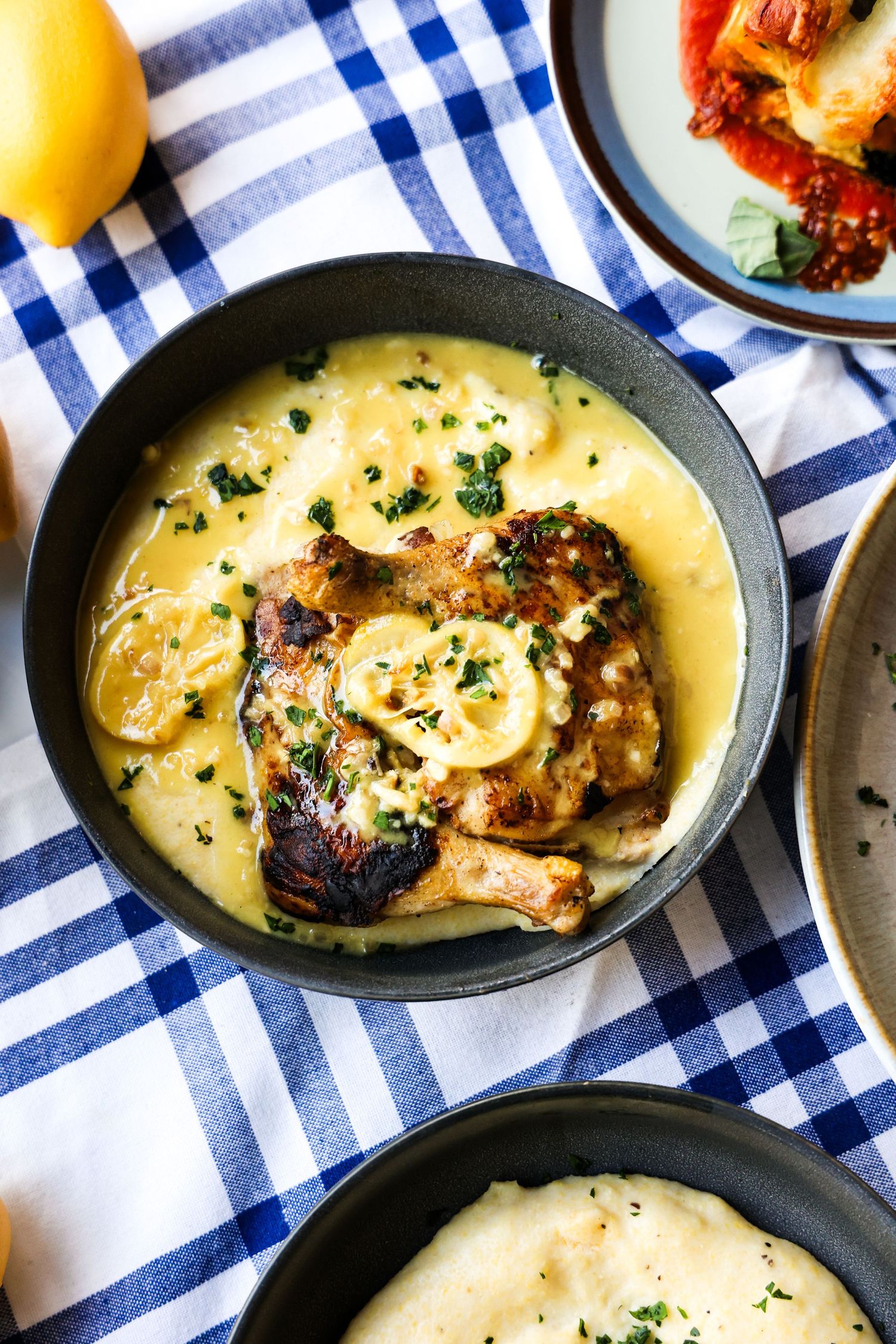 Creamy chicken dish served in cast iron skillet with blue checkered napkin.