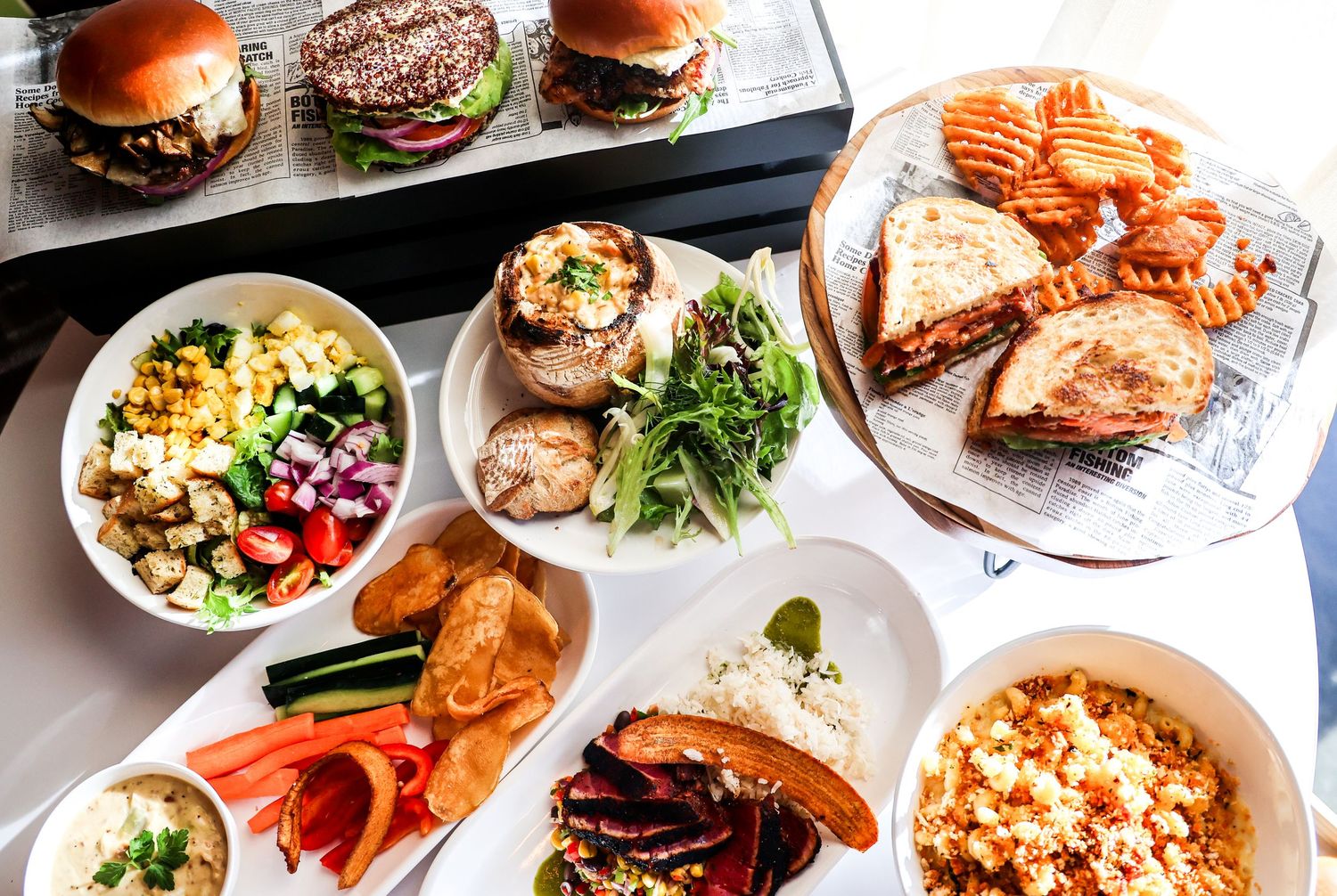Array of plated dishes and entrees showcasing diverse menu items in a restaurant setting.