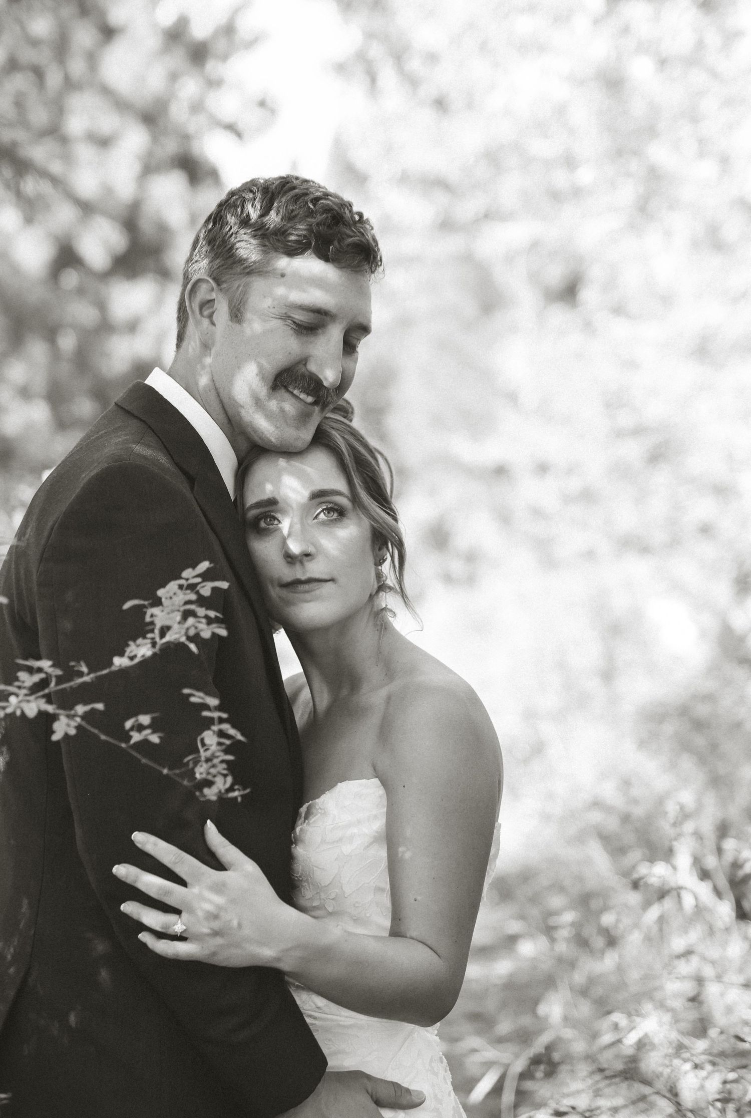 Black and white romantic wedding portraits in a natural outdoor setting.