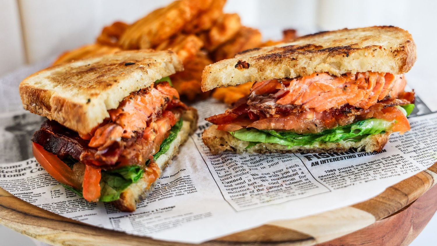 A series of grilled sandwiches with melted cheese and various fillings shown from different angles on parchment paper.