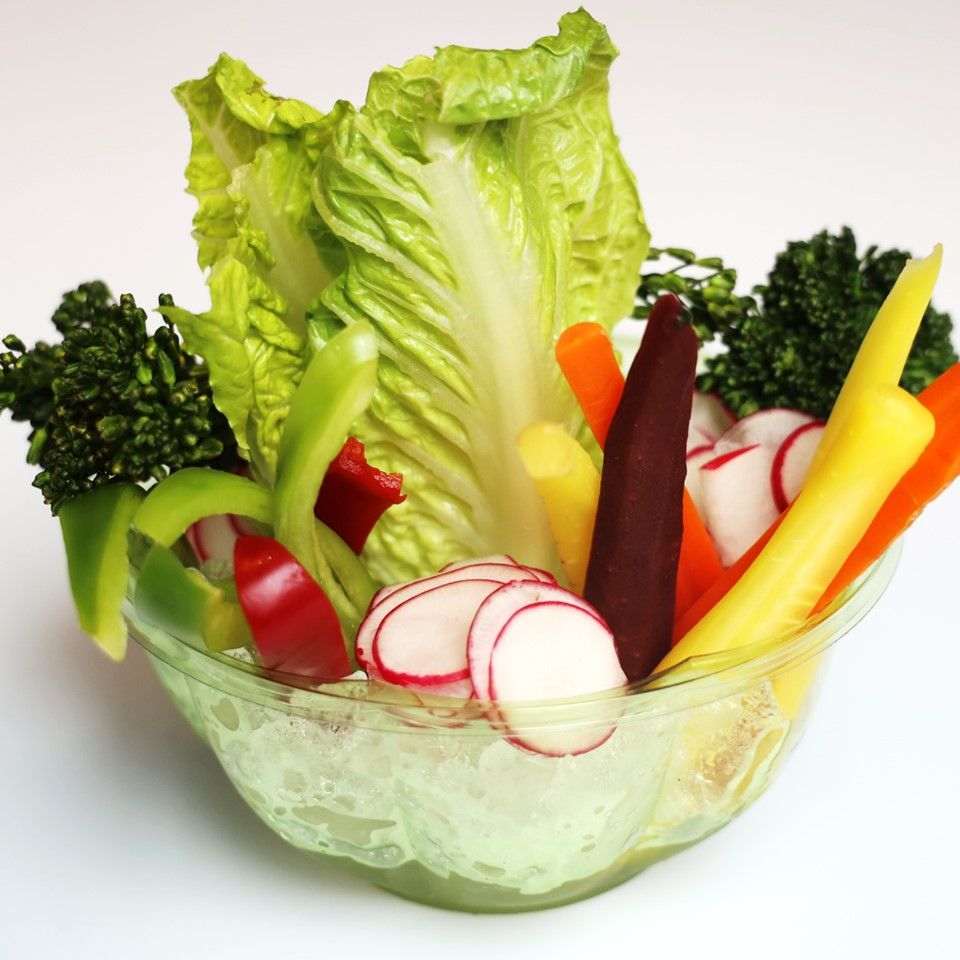 Fresh vegetable crudité platter with lettuce, radishes, and colorful bell peppers.