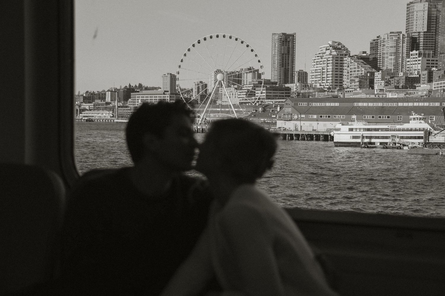 Black and white cityscape showing Seattle waterfront with ferris wheel.