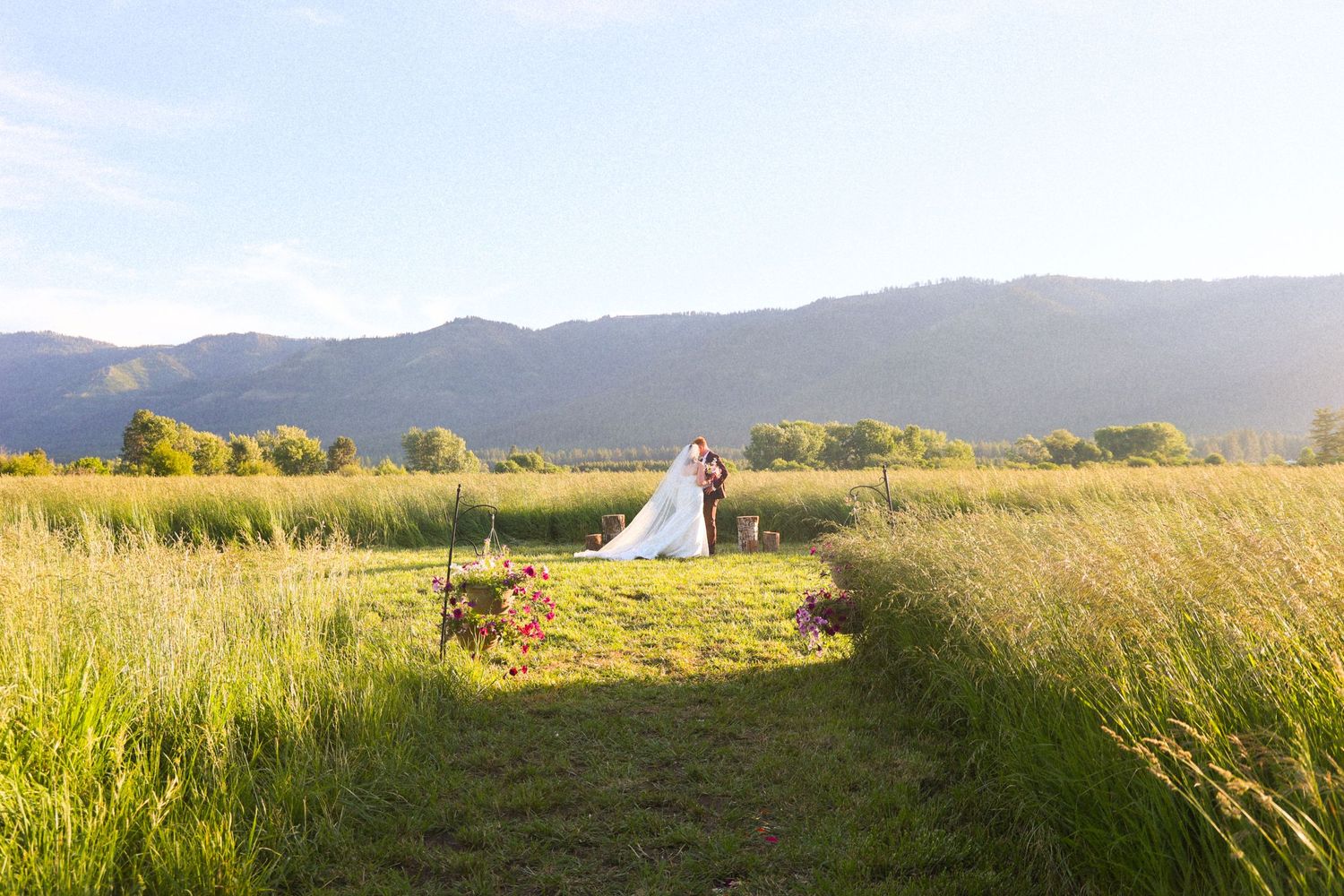 Rolling hills and mountains create a scenic landscape backdrop against a bright sky.