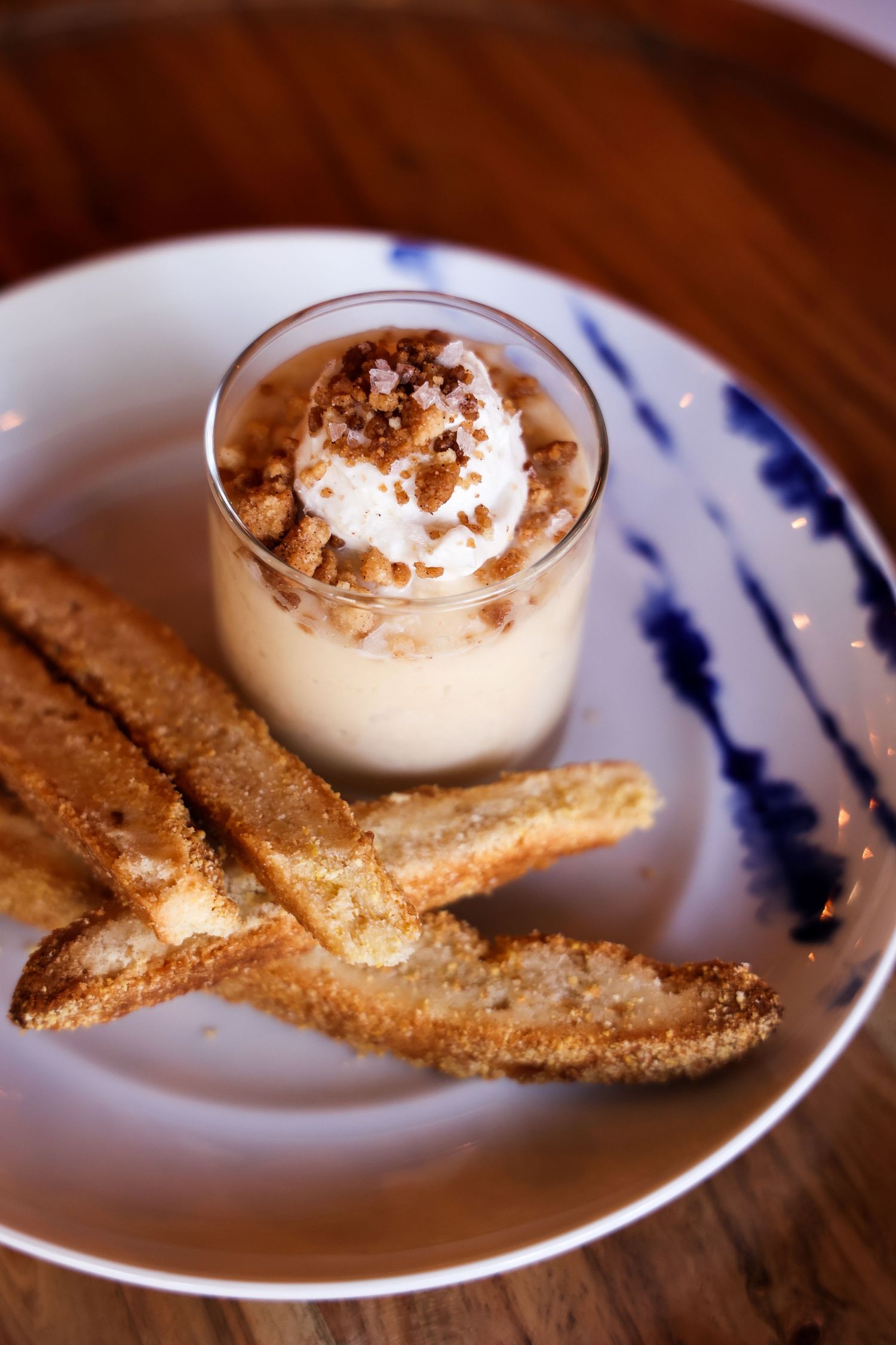 Dessert plate with graham crackers and whipped cream mousse on blue and white china.
