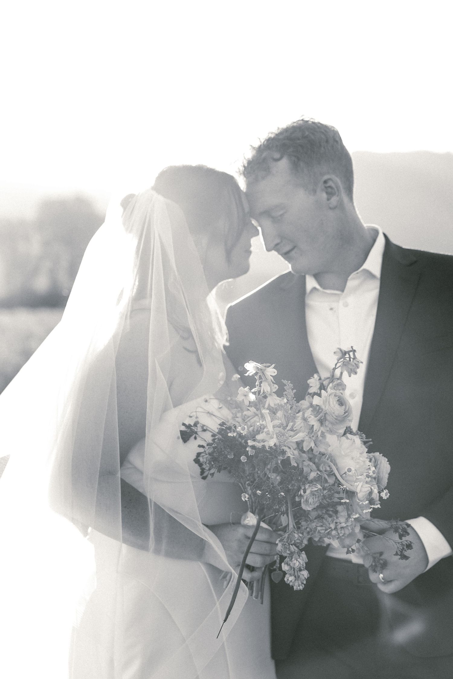 Black and white wedding photography sequence capturing intimate moments between newlyweds.