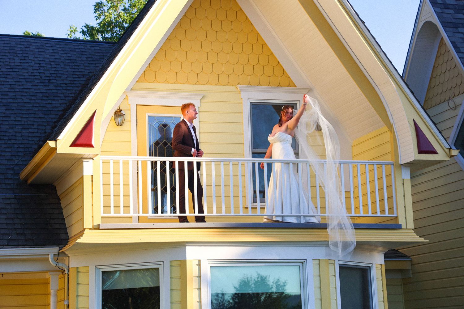 Yellow house with white trim and balconies photographed in a series of architectural detail shots.