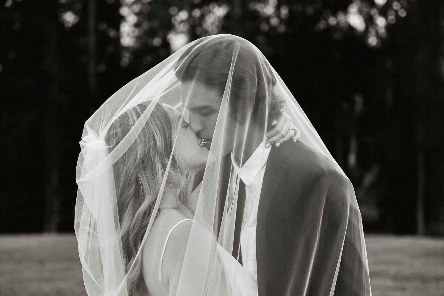 Romantic black and white sequence of a couple in wedding attire outdoors.