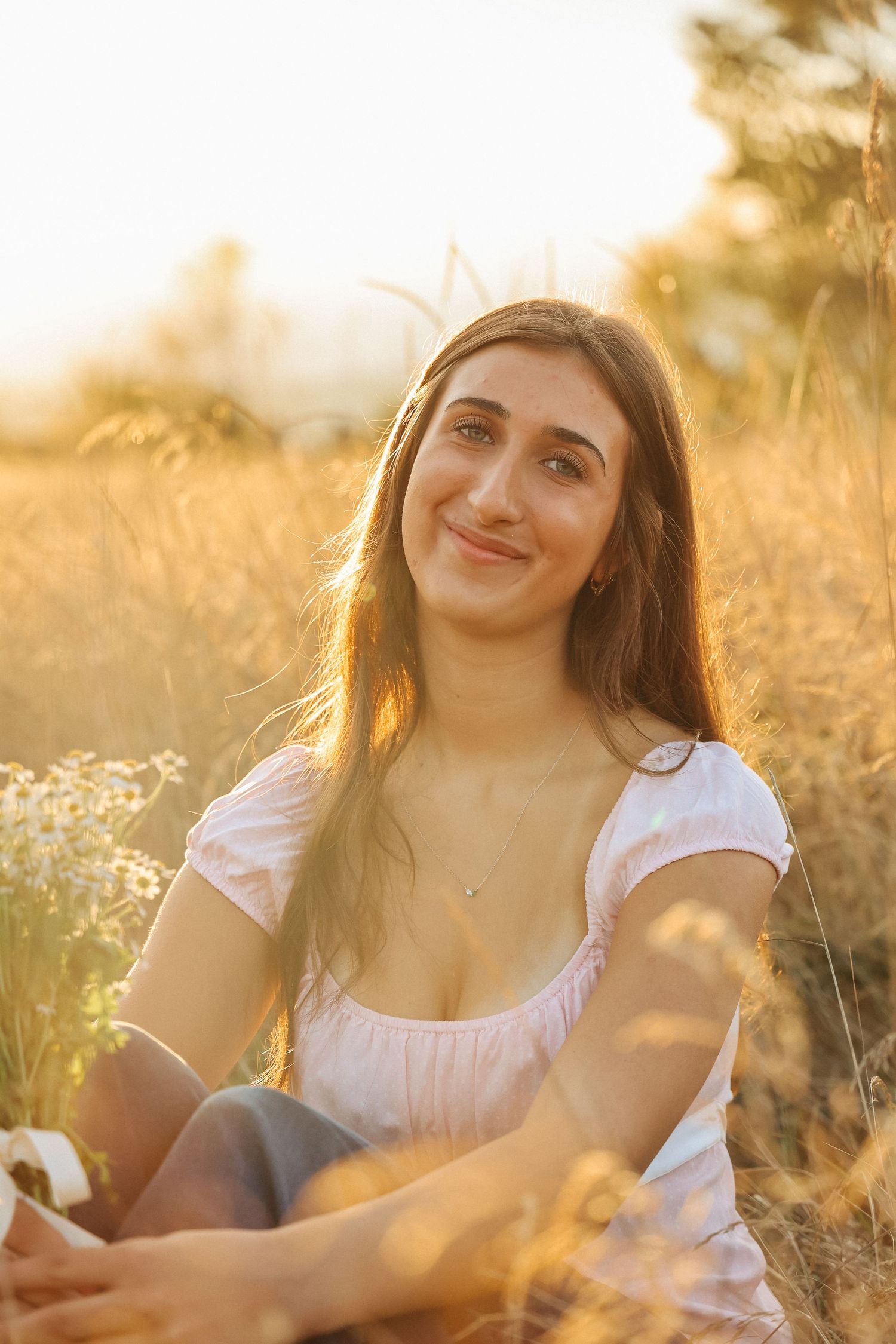 Natural outdoor portrait session in a golden field at sunset.