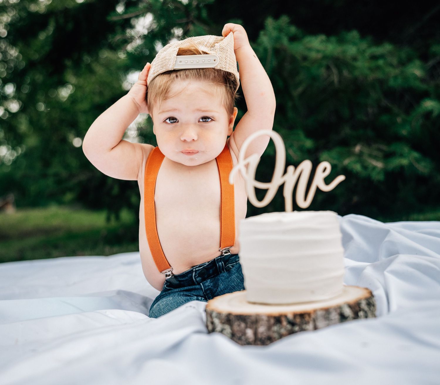 A series of five connected lifestyle photos showing someone posing with a rustic wood slice on a white blanket outdoors.