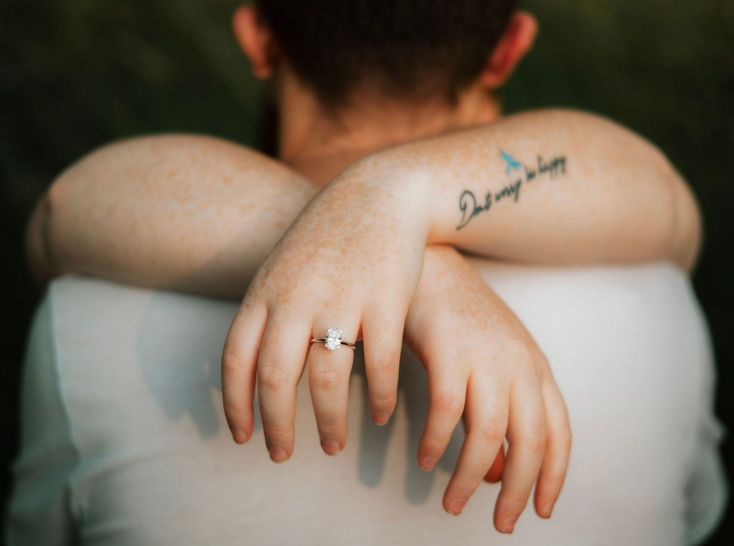 Close-up detail shots of hands and tattoos against dark background.
