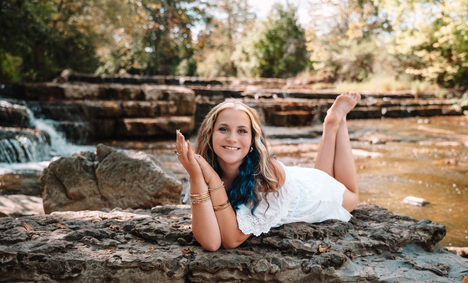 A collection of outdoor portrait photography shots taken near a cascading waterfall in natural lighting.