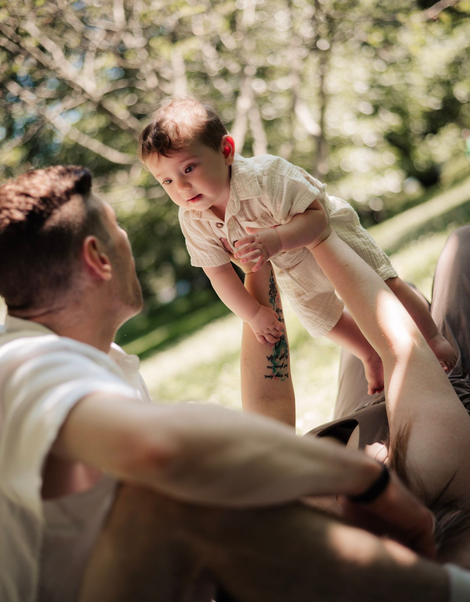 An intimate sequence showing parent and child interaction in dappled sunlight.