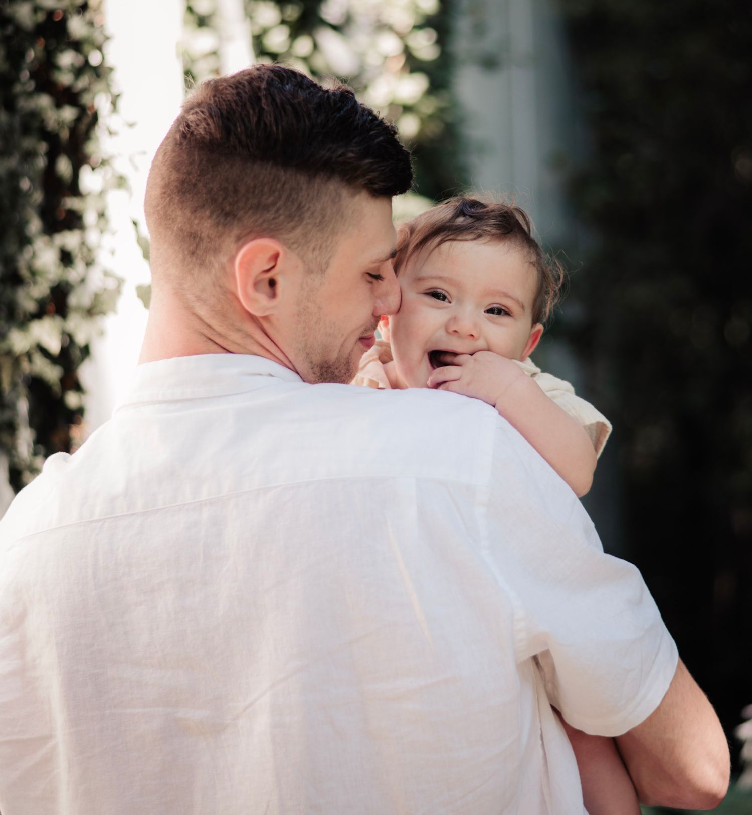 Intimate family portrait capturing a joyful moment against a softly blurred background.