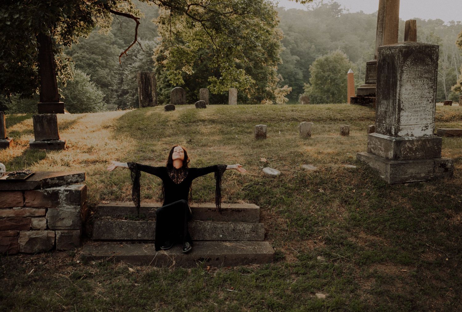 A cinematic series of graveyard photos showing stone monuments and markers among trees in moody autumn light.