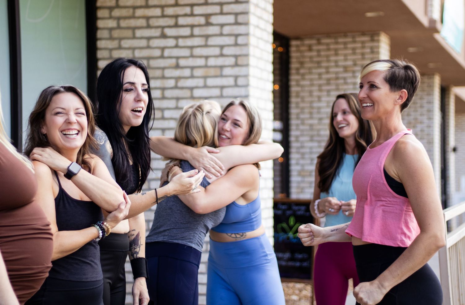 A sequence of dance partners practicing together in a brick-walled studio during a social dance class.